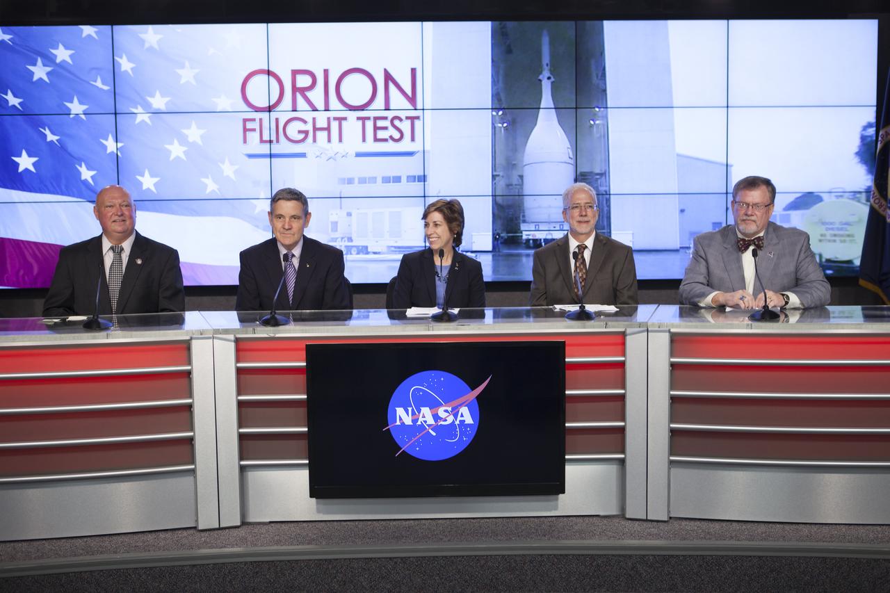 In the Kennedy Space Center’s Press Site auditorium, agency leaders spoke to members of the news media as the completed Orion spacecraft was being prepared for its trip from the Launch Abort System Facility to Launch Complex 37 at Cape Canaveral Air Force Station. From left are: Mike Curie of NASA Public Affairs, Kennedy Director Bob Cabana, Johnson Space Center Director Ellen Ochoa, NASA Orion Program manager Mark Geyer, and Lockheed Martin Orion Program manager Mike Hawes. Orion is the exploration spacecraft designed to carry astronauts to destinations not yet explored by humans, including an asteroid and Mars. It will have emergency abort capability, sustain the crew during space travel and provide safe re-entry from deep space return velocities. The first unpiloted flight test of Orion is scheduled to launch Dec. 4, 2014 atop a United Launch Alliance Delta IV Heavy rocket, and in 2018 on NASA’s Space Launch System rocket.