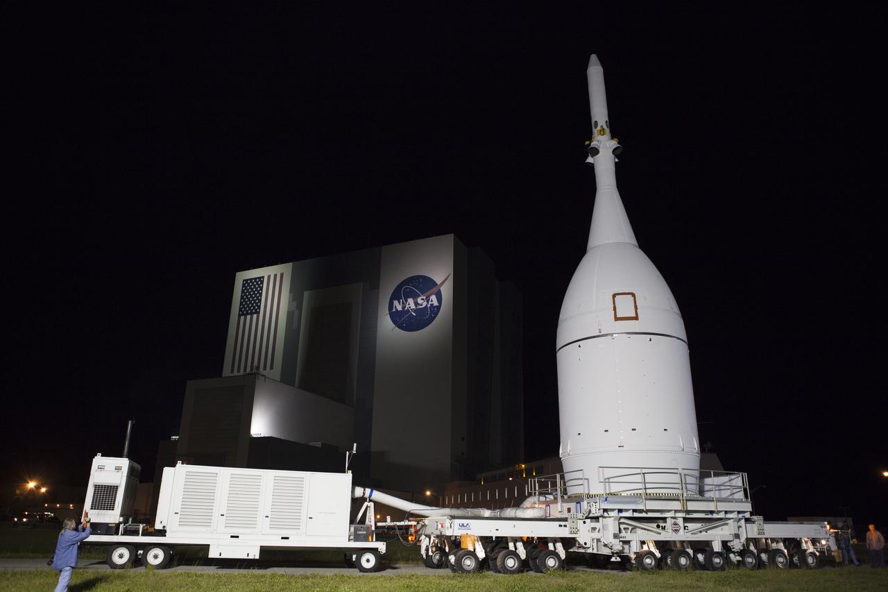 At NASA's Kennedy Space Center in Florida, the agency's Orion spacecraft passes the spaceport's iconic Vehicle Assembly Building as it is transported to Launch Complex 37 at Cape Canaveral Air Force Station. After arrival at the launch pad, United Launch Alliance engineers and technicians will lift Orion and mount it atop its Delta IV Heavy rocket. Orion is the exploration spacecraft designed to carry astronauts to destinations not yet explored by humans, including an asteroid and Mars. It will have emergency abort capability, sustain the crew during space travel and provide safe re-entry from deep space return velocities. The first unpiloted flight test of Orion is scheduled to launch Dec. 4, 2014 atop a United Launch Alliance Delta IV Heavy rocket, and in 2018 on NASA’s Space Launch System rocket.