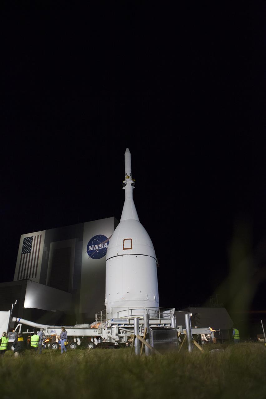 At NASA's Kennedy Space Center in Florida, the agency's Orion spacecraft passes the spaceport's iconic Vehicle Assembly Building as it is transported to Launch Complex 37 at Cape Canaveral Air Force Station. After arrival at the launch pad, United Launch Alliance engineers and technicians will lift Orion and mount it atop its Delta IV Heavy rocket. Orion is the exploration spacecraft designed to carry astronauts to destinations not yet explored by humans, including an asteroid and Mars. It will have emergency abort capability, sustain the crew during space travel and provide safe re-entry from deep space return velocities. The first unpiloted flight test of Orion is scheduled to launch Dec. 4, 2014 atop a United Launch Alliance Delta IV Heavy rocket, and in 2018 on NASA’s Space Launch System rocket.