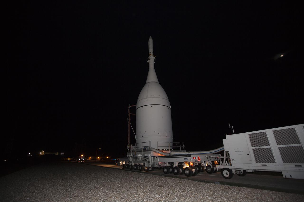 At NASA's Kennedy Space Center in Florida, the agency's Orion spacecraft approaches the spaceport's Launch Complex 39B as it is transported to Launch Complex 37 at Cape Canaveral Air Force Station. After arrival at the launch pad, United Launch Alliance engineers and technicians will lift Orion and mount it atop its Delta IV Heavy rocket. Orion is the exploration spacecraft designed to carry astronauts to destinations not yet explored by humans, including an asteroid and Mars. It will have emergency abort capability, sustain the crew during space travel and provide safe re-entry from deep space return velocities. The first unpiloted flight test of Orion is scheduled to launch Dec. 4, 2014 atop a United Launch Alliance Delta IV Heavy rocket, and in 2018 on NASA’s Space Launch System rocket. 