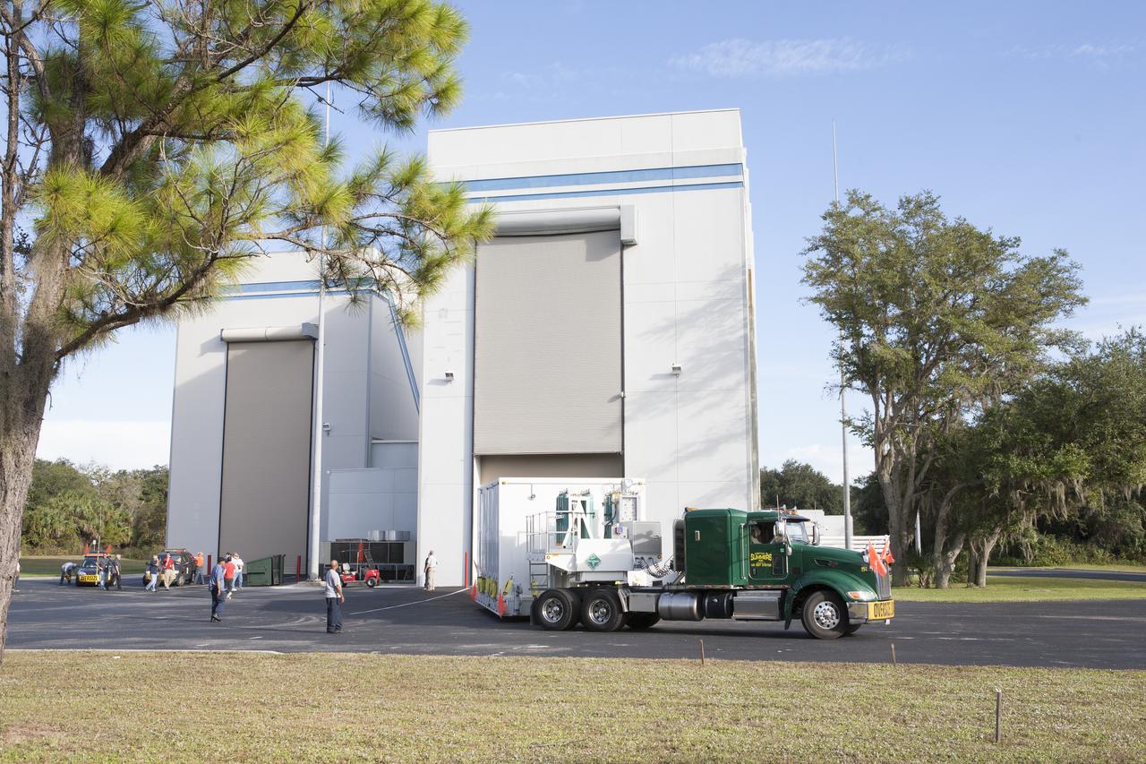 Two Magnetospheric Multiscale spacecraft, enclosed in a protective shipping container, are delivered by truck to the Astrotech payload processing facility in Titusville, Florida, near Kennedy Space Center. The Magnetospheric Multiscale mission, or MMS, is a Solar Terrestrial Probes mission comprising four identically instrumented spacecraft that will use Earth’s magnetosphere as a laboratory to study the microphysics of three fundamental plasma processes: magnetic reconnection, energetic particle acceleration and turbulence. These two spacecraft comprise the mission's upper stack. The two MMS spacecraft comprising the lower stack arrived at Astrotech on Oct. 29. Launch aboard a United Launch Alliance Atlas V rocket from Space Launch Complex 41 on Cape Canaveral Air Force Station is targeted for March 12, 2015.