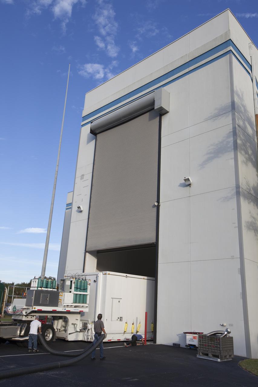 The airlock door opens at Building 2 of the Astrotech payload processing facility in Titusville, Florida, near Kennedy Space Center, for ingress of the protective shipping container enclosing the Magnetospheric Multiscale spacecraft. The Magnetospheric Multiscale mission, or MMS, is a Solar Terrestrial Probes mission comprising four identically instrumented spacecraft that will use Earth’s magnetosphere as a laboratory to study the microphysics of three fundamental plasma processes: magnetic reconnection, energetic particle acceleration and turbulence. These two spacecraft comprise the mission's upper stack. The two MMS spacecraft comprising the lower stack arrived at Astrotech on Oct. 29. Launch aboard a United Launch Alliance Atlas V rocket from Space Launch Complex 41 on Cape Canaveral Air Force Station is targeted for March 12, 2015. 