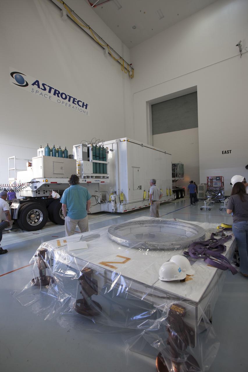 Operations are underway to remove two of the the Magnetospheric Multiscale spacecraft from their protective shipping container in the airlock of Building 2 at the Astrotech payload processing facility in Titusville, Florida, near Kennedy Space Center. The Magnetospheric Multiscale mission, or MMS, is a Solar Terrestrial Probes mission comprising four identically instrumented spacecraft that will use Earth’s magnetosphere as a laboratory to study the microphysics of three fundamental plasma processes: magnetic reconnection, energetic particle acceleration and turbulence. These two spacecraft comprise the mission's upper stack. The two MMS spacecraft comprising the lower stack arrived at Astrotech on Oct. 29. Launch aboard a United Launch Alliance Atlas V rocket from Space Launch Complex 41 on Cape Canaveral Air Force Station is targeted for March 12, 2015.