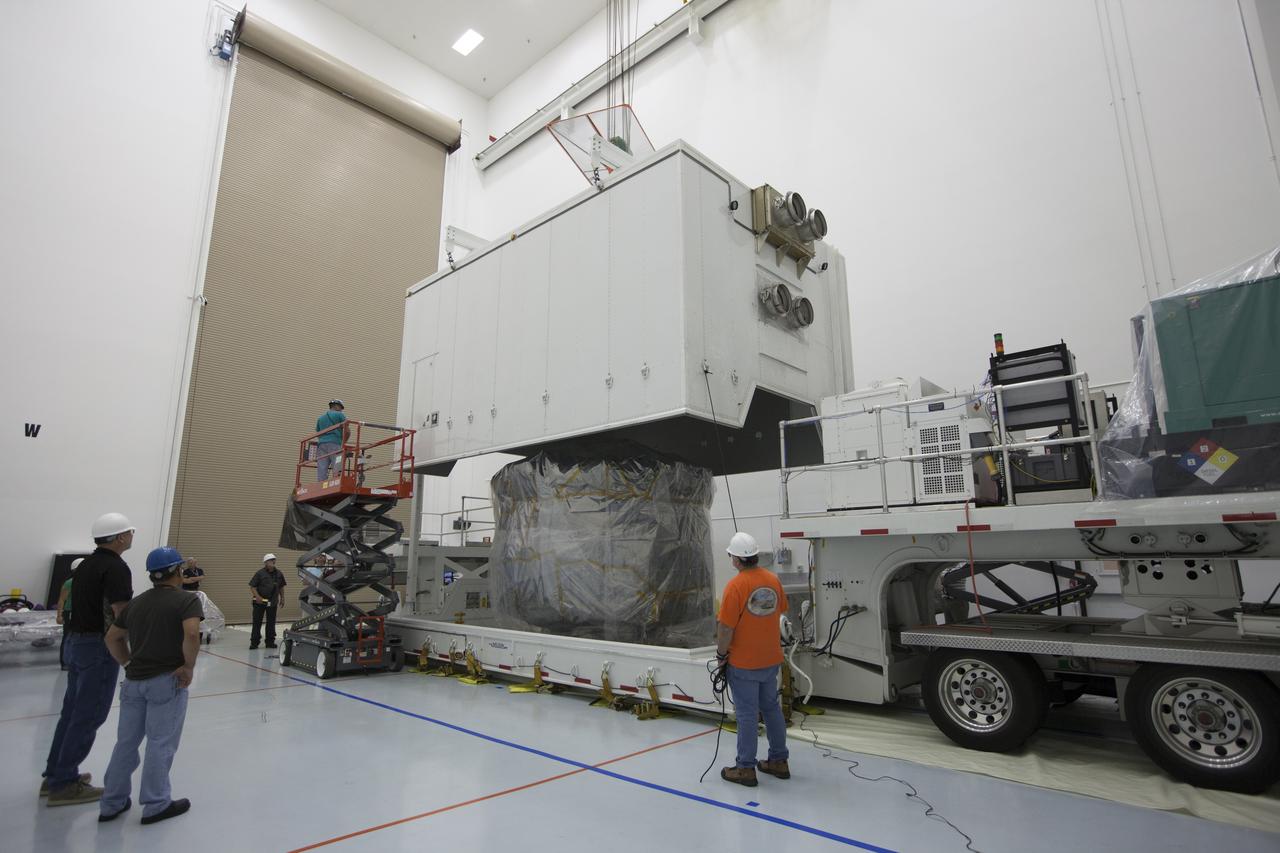 Two Magnetospheric Multiscale, or MMS, spacecraft, comprising the mission's upper stack, come into view as the shipping container is removed in Building 2 of the Astrotech payload processing facility in Titusville, Florida, near Kennedy Space Center. The two MMS spacecraft comprising the lower stack arrived at Astrotech on Oct. 29. The Magnetospheric Multiscale mission is a Solar Terrestrial Probes mission comprising four identically instrumented spacecraft that will use Earth’s magnetosphere as a laboratory to study the microphysics of three fundamental plasma processes: magnetic reconnection, energetic particle acceleration and turbulence. Launch aboard a United Launch Alliance Atlas V rocket from Space Launch Complex 41 on Cape Canaveral Air Force Station is targeted for March 12, 2015.