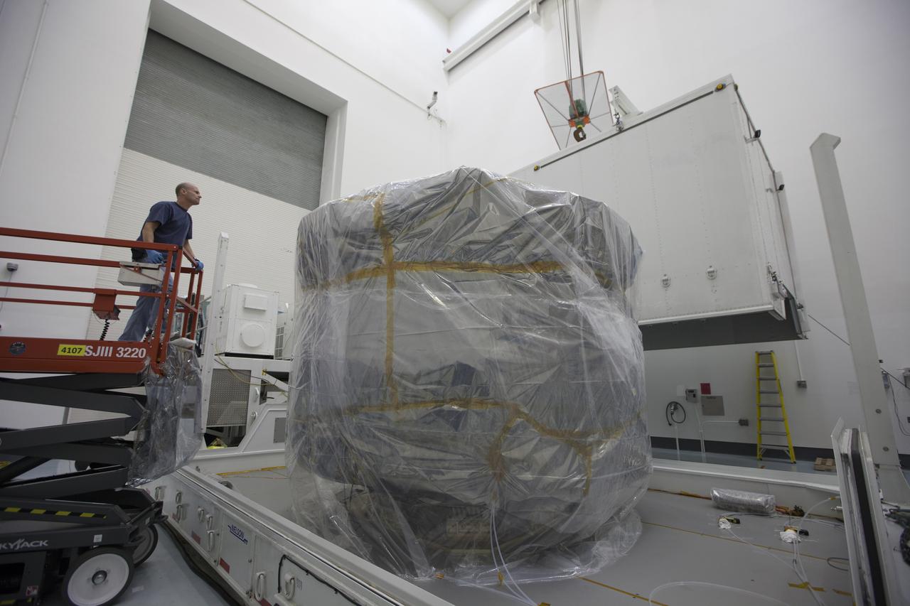 The protective shipping container is removed from around the upper stack of the Magnetospheric Multiscale, or MMS, spacecraft in Building 2 of the Astrotech payload processing facility in Titusville, Florida, near Kennedy Space Center. The two MMS spacecraft comprising the lower stack arrived at Astrotech on Oct. 29. The Magnetospheric Multiscale mission is a Solar Terrestrial Probes mission comprising four identically instrumented spacecraft that will use Earth’s magnetosphere as a laboratory to study the microphysics of three fundamental plasma processes: magnetic reconnection, energetic particle acceleration and turbulence. Launch aboard a United Launch Alliance Atlas V rocket from Space Launch Complex 41 on Cape Canaveral Air Force Station is targeted for March 12, 2015.