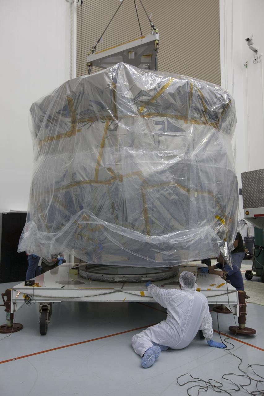 Two Magnetospheric Multiscale , or MMS, spacecraft comprising the mission’s upper stack are lowered onto a payload dolly in Building 2 of the Astrotech payload processing facility in Titusville, Florida, near Kennedy Space Center. The two MMS spacecraft comprising the lower stack arrived at Astrotech on Oct. 29. The Magnetospheric Multiscale mission is a Solar Terrestrial Probes mission comprising four identically instrumented spacecraft that will use Earth’s magnetosphere as a laboratory to study the microphysics of three fundamental plasma processes: magnetic reconnection, energetic particle acceleration and turbulence. Launch aboard a United Launch Alliance Atlas V rocket from Space Launch Complex 41 on Cape Canaveral Air Force Station is targeted for March 12, 2015. 