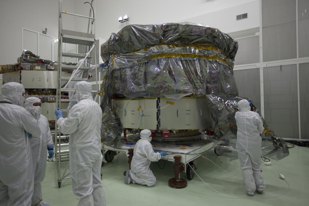 The protective covering is removed from the two Magnetospheric Multiscale, or MMS, spacecraft comprising the mission’s upper stack in the Building 1 high bay of the Astrotech payload processing facility in Titusville, Florida, near Kennedy Space Center. The two MMS spacecraft comprising the lower stack arrived at Astrotech on Oct. 29. The Magnetospheric Multiscale mission is a Solar Terrestrial Probes mission comprising four identically instrumented spacecraft that will use Earth’s magnetosphere as a laboratory to study the microphysics of three fundamental plasma processes: magnetic reconnection, energetic particle acceleration and turbulence. Launch aboard a United Launch Alliance Atlas V rocket from Space Launch Complex 41 on Cape Canaveral Air Force Station is targeted for March 12, 2015. 
