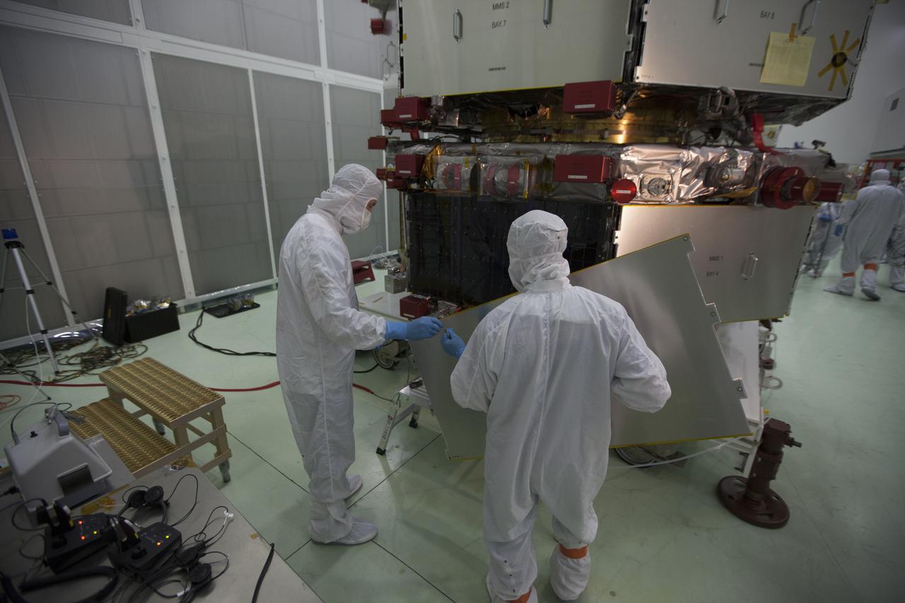 Workers inspect the solar arrays on the Magnetospheric Multiscale, or MMS, observatories in the Building 1 D high bay of the Astrotech payload processing facility in Titusville, Florida, near Kennedy Space Center. The two MMS spacecraft comprising the upper deck arrived Nov. 12; the two comprising the lower stack arrived Oct. 29. MMS, led by a team from NASA's Goddard Space Flight Center, is a Solar Terrestrial Probes mission consisting of four identically instrumented spacecraft that will use Earth’s magnetosphere as a laboratory to study the microphysics of three fundamental plasma processes: magnetic reconnection, energetic particle acceleration and turbulence. Launch aboard a United Launch Alliance Atlas V rocket from Space Launch Complex 41 on Cape Canaveral Air Force Station is targeted for March 12, 2015. 