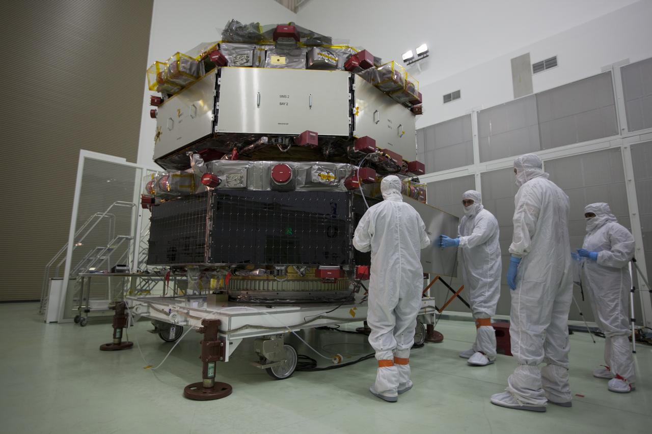 Workers inspect the solar arrays on the Magnetospheric Multiscale, or MMS, observatories in the Building 1 D high bay of the Astrotech payload processing facility in Titusville, Florida, near Kennedy Space Center. The two MMS spacecraft comprising the upper deck arrived Nov. 12; the two comprising the lower stack arrived Oct. 29. MMS, led by a team from NASA's Goddard Space Flight Center, is a Solar Terrestrial Probes mission consisting of four identically instrumented spacecraft that will use Earth’s magnetosphere as a laboratory to study the microphysics of three fundamental plasma processes: magnetic reconnection, energetic particle acceleration and turbulence. Launch aboard a United Launch Alliance Atlas V rocket from Space Launch Complex 41 on Cape Canaveral Air Force Station is targeted for March 12, 2015.