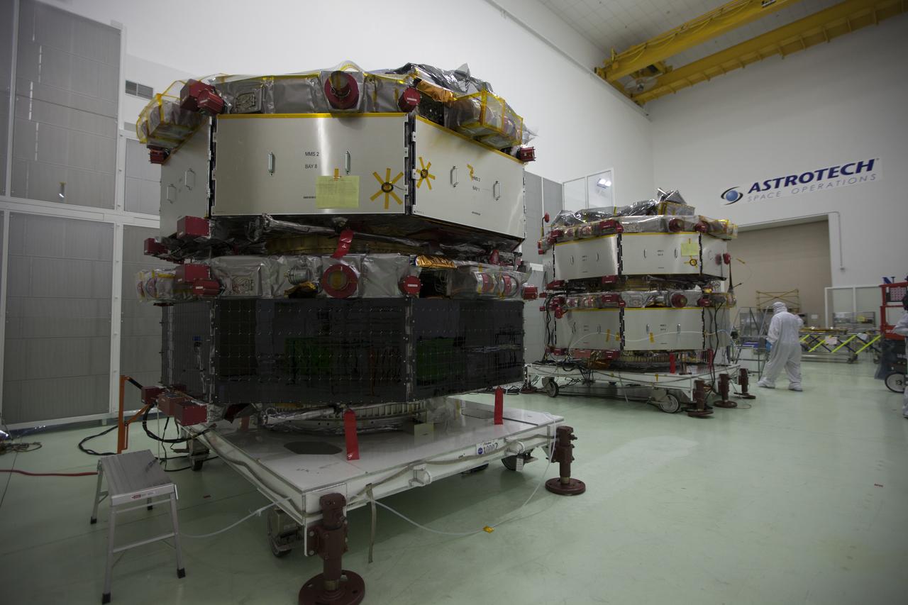The solar arrays on the Magnetospheric Multiscale, or MMS, observatories are uncovered for an inspection in the Building 1 D high bay of the Astrotech payload processing facility in Titusville, Florida, near Kennedy Space Center. The two MMS spacecraft comprising the upper deck arrived Nov. 12; the two comprising the lower stack arrived Oct. 29. MMS, led by a team from NASA's Goddard Space Flight Center, is a Solar Terrestrial Probes mission consisting of four identically instrumented spacecraft that will use Earth’s magnetosphere as a laboratory to study the microphysics of three fundamental plasma processes: magnetic reconnection, energetic particle acceleration and turbulence. Launch aboard a United Launch Alliance Atlas V rocket from Space Launch Complex 41 on Cape Canaveral Air Force Station is targeted for March 12, 2015.