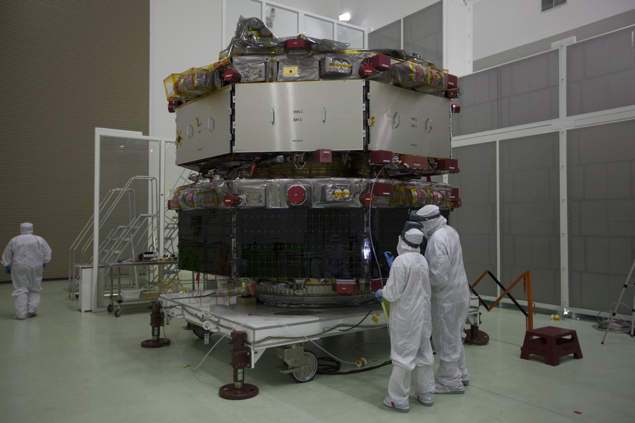 Workers inspect the solar arrays on the Magnetospheric Multiscale, or MMS, observatories in the Building 1 D high bay of the Astrotech payload processing facility in Titusville, Florida, near Kennedy Space Center. The two MMS spacecraft comprising the upper deck arrived Nov. 12; the two comprising the lower stack arrived Oct. 29. MMS, led by a team from NASA's Goddard Space Flight Center, is a Solar Terrestrial Probes mission consisting of four identically instrumented spacecraft that will use Earth’s magnetosphere as a laboratory to study the microphysics of three fundamental plasma processes: magnetic reconnection, energetic particle acceleration and turbulence. Launch aboard a United Launch Alliance Atlas V rocket from Space Launch Complex 41 on Cape Canaveral Air Force Station is targeted for March 12, 2015.