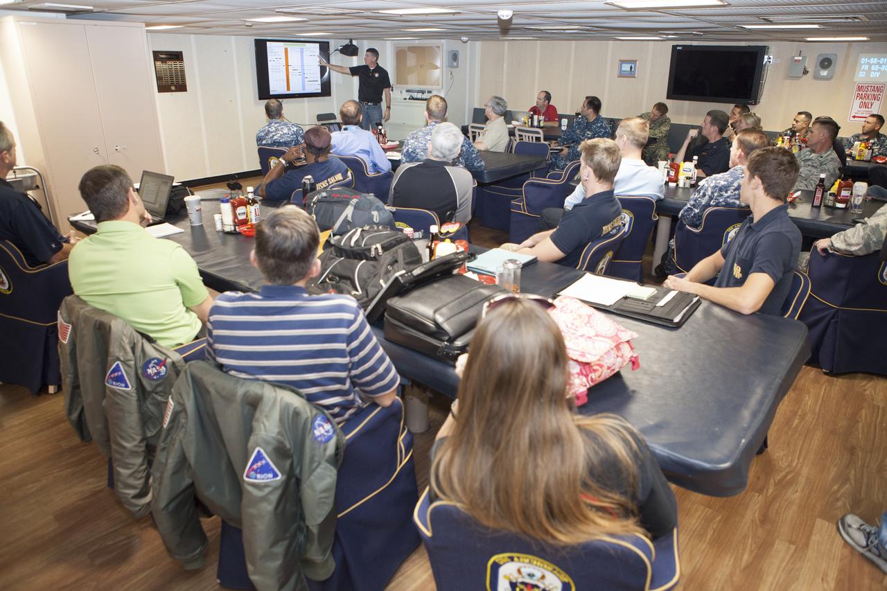 NASA Orion Recovery Director Jeremy Graeber, with the Ground Systems Development and Operations Program at Kennedy Space Center in Florida, reviews Orion recovery procedures with NASA, Lockheed Martin and U.S. Navy personnel aboard the USS Anchorage at Naval Base San Diego in California. Before the launch of Orion on its first flight test atop a Delta IV Heavy rocket from Cape Canaveral Air Force Station in Florida, NASA, Lockheed Martin and the U.S. Navy personnel will head out to sea in the USS Anchorage and the USNS Salvor, a salvage ship, and wait for splashdown of the Orion crew module in the Pacific Ocean. The GSDO Program will lead the recovery efforts. Orion is the exploration spacecraft designed to carry astronauts to destinations not yet explored by humans, including an asteroid and Mars. It will have emergency abort capability, sustain the crew during space travel and provide safe re-entry from deep space return velocities. The first unpiloted flight test of Orion is scheduled to launch in December atop a United Launch Alliance Delta IV Heavy rocket and in 2018 on NASA’s Space Launch System rocket. 