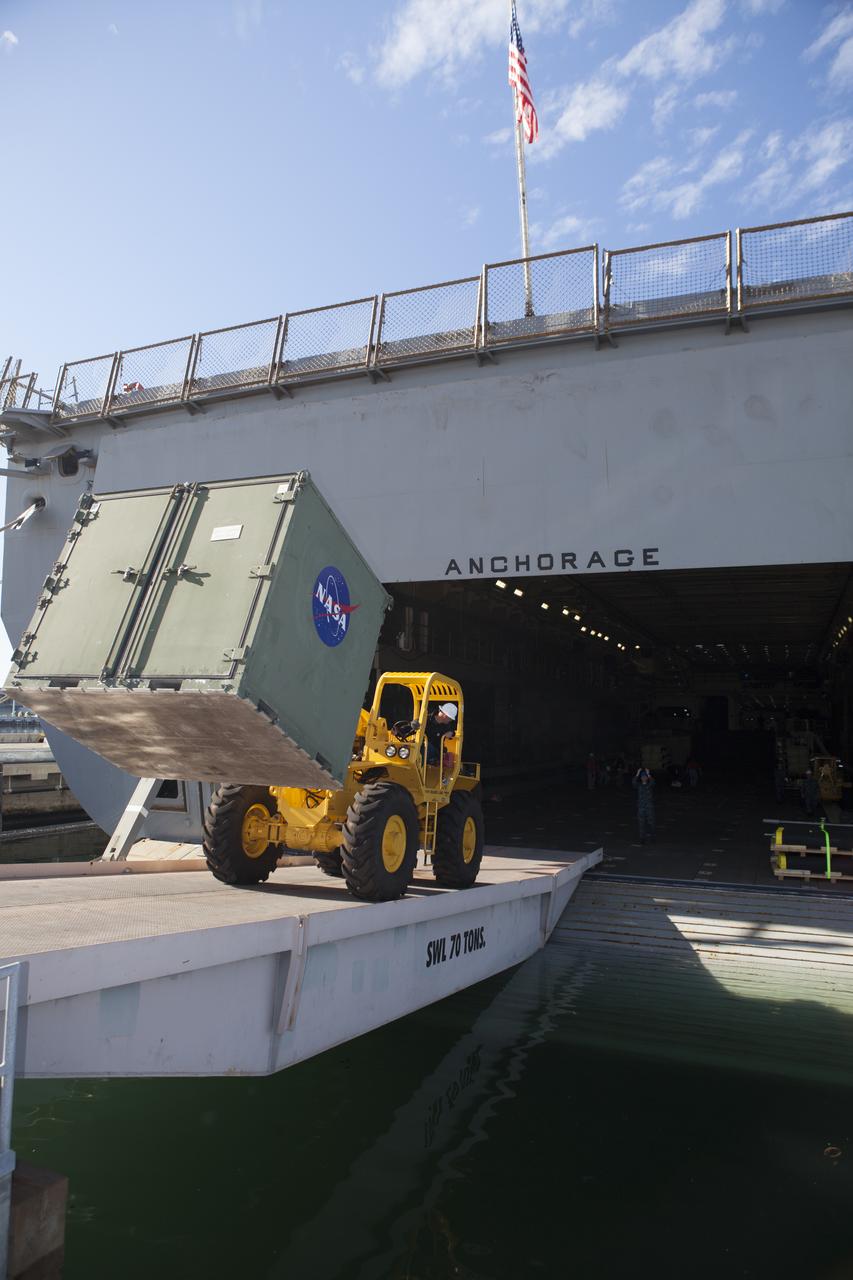 A forklift is used to carry ground support equipment into the well deck of the USS Anchorage at Naval Base San Diego in California. The equipment will be used during recovery of the Orion crew module after its first flight test. Before launch of Orion on a Delta IV Heavy rocket from Cape Canaveral Air Force Station in Florida, NASA, Lockheed Martin and U.S. Navy personnel will head out to sea in the USS Anchorage and the USNS Salvor, a salvage ship, and wait for splashdown of the Orion crew module in the Pacific Ocean. The Ground Systems Development and Operations Program will lead the recovery efforts. Orion is the exploration spacecraft designed to carry astronauts to destinations not yet explored by humans, including an asteroid and Mars. It will have emergency abort capability, sustain the crew during space travel and provide safe re-entry from deep space return velocities. The first unpiloted flight test of Orion is scheduled to launch in December atop a United Launch Alliance Delta IV Heavy rocket and in 2018 on NASA’s Space Launch System rocket.