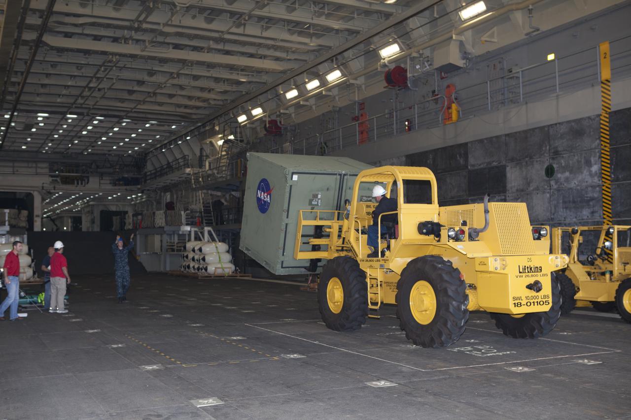 A forklift is used to carry ground support equipment into the well deck of the USS Anchorage at Naval Base San Diego in California. The equipment will be used during recovery of the Orion crew module after its first flight test. Before launch of Orion on a Delta IV Heavy rocket from Cape Canaveral Air Force Station in Florida, NASA, Lockheed Martin and U.S. Navy personnel will head out to sea in the USS Anchorage and the USNS Salvor, a salvage ship, and wait for splashdown of the Orion crew module in the Pacific Ocean. The Ground Systems Development and Operations Program will lead the recovery efforts. Orion is the exploration spacecraft designed to carry astronauts to destinations not yet explored by humans, including an asteroid and Mars. It will have emergency abort capability, sustain the crew during space travel and provide safe re-entry from deep space return velocities. The first unpiloted flight test of Orion is scheduled to launch in December atop a United Launch Alliance Delta IV Heavy rocket and in 2018 on NASA’s Space Launch System rocket.