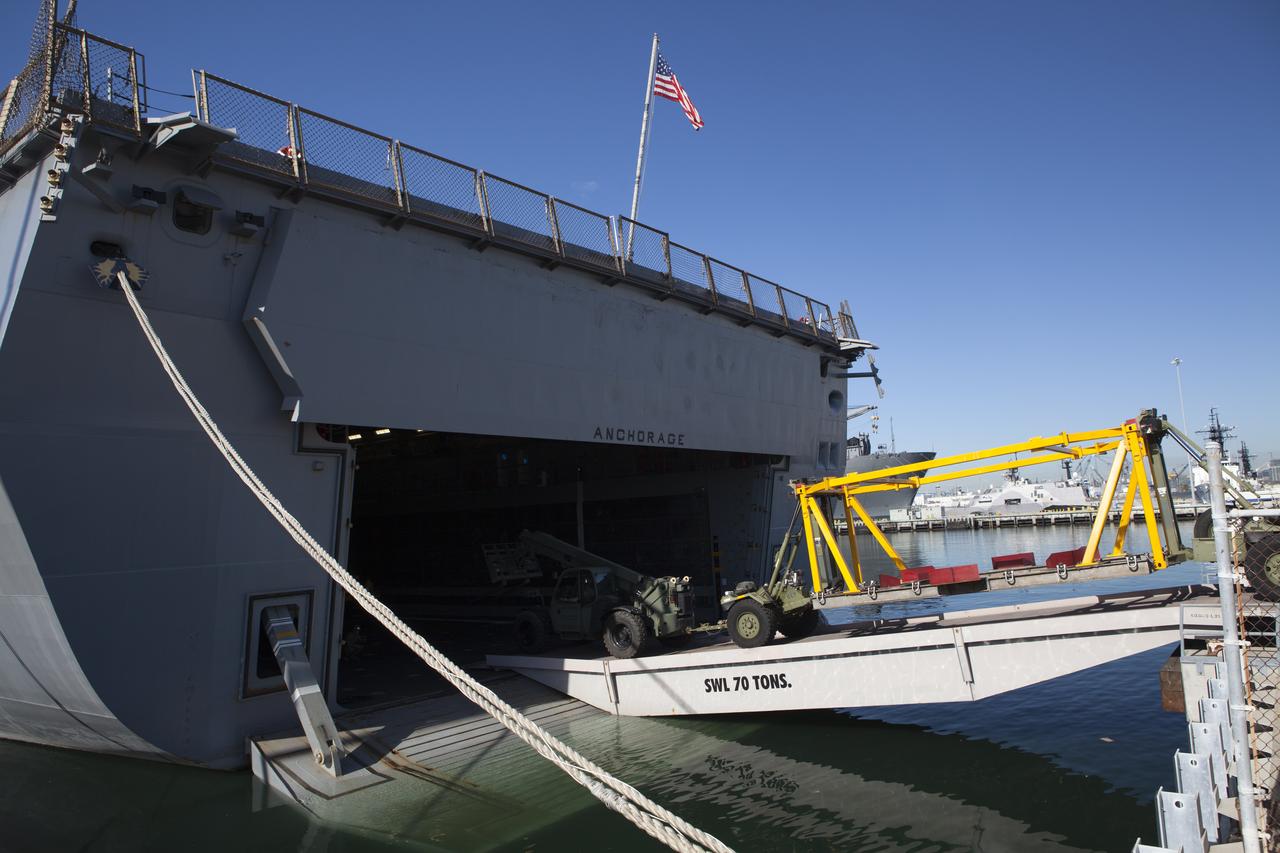 Ground support equipment is being loaded into the well deck of the USS Anchorage at Naval Base San Diego in California. The equipment will be used during recovery of the Orion crew module after its first flight test. Before launch of Orion on a Delta IV Heavy rocket from Cape Canaveral Air Force Station in Florida, NASA, Lockheed Martin and U.S. Navy personnel will head out to sea in the USS Anchorage and the USNS Salvor, a salvage ship, and wait for splashdown of the Orion crew module in the Pacific Ocean. The Ground Systems Development and Operations Program will lead the recovery efforts. Orion is the exploration spacecraft designed to carry astronauts to destinations not yet explored by humans, including an asteroid and Mars. It will have emergency abort capability, sustain the crew during space travel and provide safe re-entry from deep space return velocities. The first unpiloted flight test of Orion is scheduled to launch in December atop a United Launch Alliance Delta IV Heavy rocket and in 2018 on NASA’s Space Launch System rocket.
