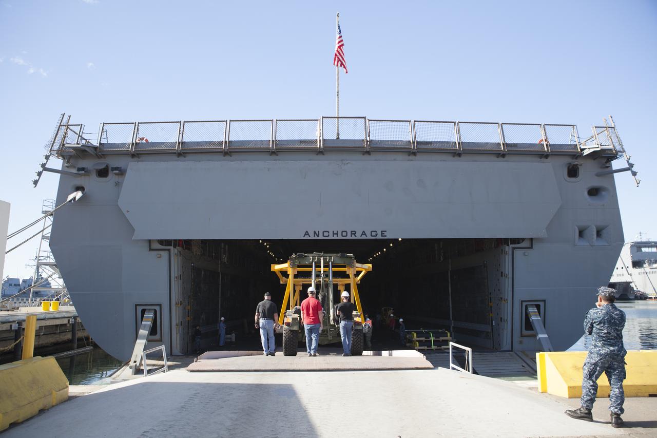 Ground support equipment is being loaded into the well deck of the USS Anchorage at Naval Base San Diego in California. The equipment will be used during recovery of the Orion crew module after its first flight test. Before launch of Orion on a Delta IV Heavy rocket from Cape Canaveral Air Force Station in Florida, NASA, Lockheed Martin and U.S. Navy personnel will head out to sea in the USS Anchorage and the USNS Salvor, a salvage ship, and wait for splashdown of the Orion crew module in the Pacific Ocean. The Ground Systems Development and Operations Program will lead the recovery efforts. Orion is the exploration spacecraft designed to carry astronauts to destinations not yet explored by humans, including an asteroid and Mars. It will have emergency abort capability, sustain the crew during space travel and provide safe re-entry from deep space return velocities. The first unpiloted flight test of Orion is scheduled to launch in December atop a United Launch Alliance Delta IV Heavy rocket and in 2018 on NASA’s Space Launch System rocket. 