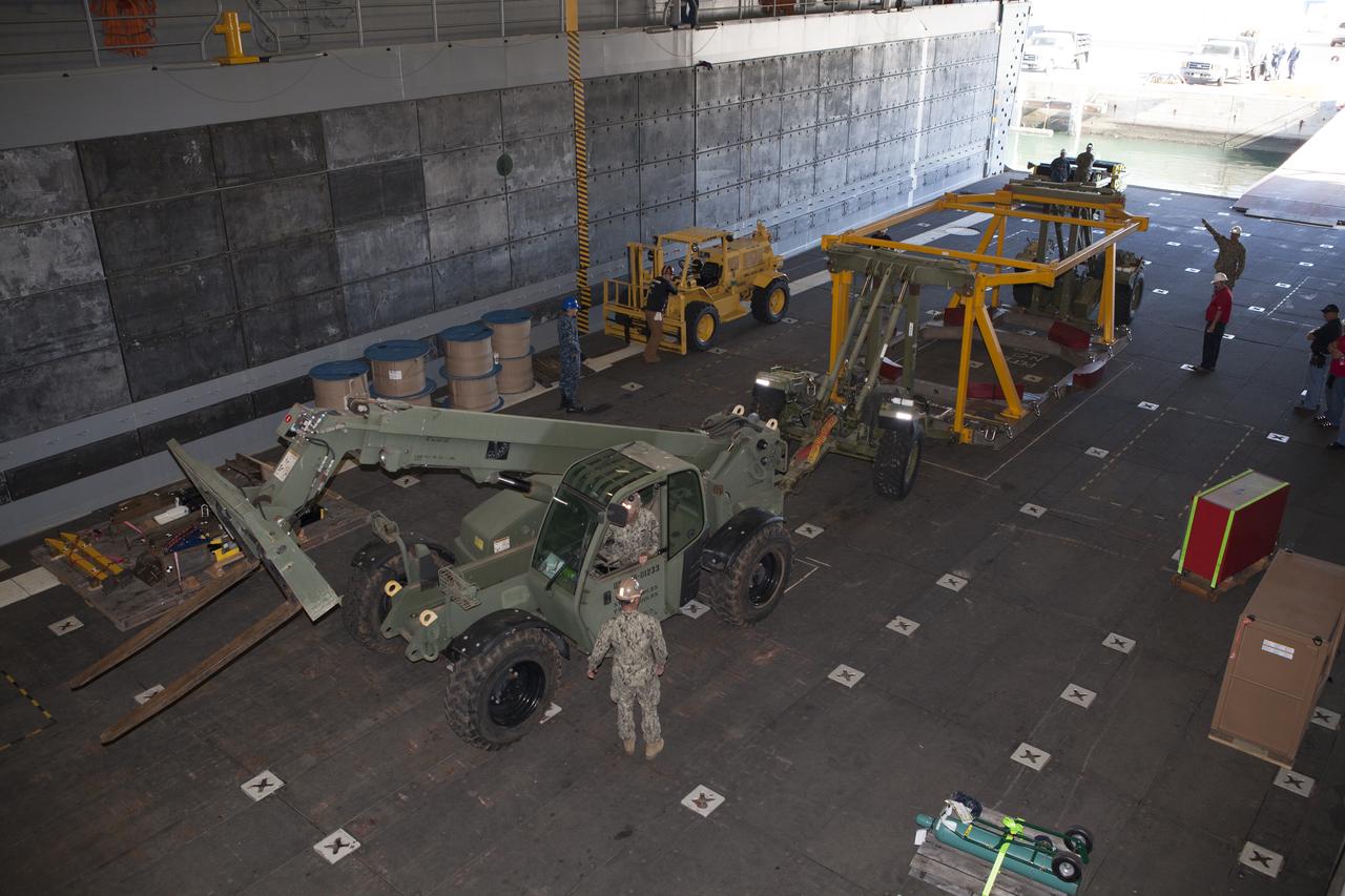 The Orion crew module recovery fixture is being loaded into the well deck of the USS Anchorage at Naval Base San Diego in California. The equipment will be used during recovery of the Orion crew module after its first flight test. Before launch of Orion on a Delta IV Heavy rocket from Cape Canaveral Air Force Station in Florida, NASA, Lockheed Martin and U.S. Navy personnel will head out to sea in the USS Anchorage and the USNS Salvor, a salvage ship, and wait for splashdown of the Orion crew module in the Pacific Ocean. The Ground Systems Development and Operations Program will lead the recovery efforts. Orion is the exploration spacecraft designed to carry astronauts to destinations not yet explored by humans, including an asteroid and Mars. It will have emergency abort capability, sustain the crew during space travel and provide safe re-entry from deep space return velocities. The first unpiloted flight test of Orion is scheduled to launch in December atop a United Launch Alliance Delta IV Heavy rocket and in 2018 on NASA’s Space Launch System rocket. 