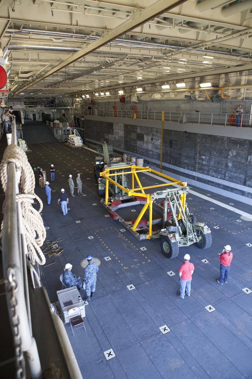 The Orion crew module recovery fixture has been loaded into the well deck of the USS Anchorage at Naval Base San Diego in California. The equipment will be used during recovery of the Orion crew module after its first flight test. Before launch of Orion on a Delta IV Heavy rocket from Cape Canaveral Air Force Station in Florida, NASA, Lockheed Martin and U.S. Navy personnel will head out to sea in the USS Anchorage and the USNS Salvor, a salvage ship, and wait for splashdown of the Orion crew module in the Pacific Ocean. The Ground Systems Development and Operations Program will lead the recovery efforts. Orion is the exploration spacecraft designed to carry astronauts to destinations not yet explored by humans, including an asteroid and Mars. It will have emergency abort capability, sustain the crew during space travel and provide safe re-entry from deep space return velocities. The first unpiloted flight test of Orion is scheduled to launch in December atop a United Launch Alliance Delta IV Heavy rocket and in 2018 on NASA’s Space Launch System rocket. 