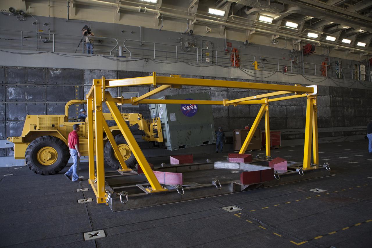 The Orion crew module recovery fixture and other ground support equipment have been loaded into the well deck of the USS Anchorage at Naval Base San Diego in California. The equipment will be used during recovery of the Orion crew module after its first flight test. Before launch of Orion on a Delta IV Heavy rocket from Cape Canaveral Air Force Station in Florida, NASA, Lockheed Martin and U.S. Navy personnel will head out to sea in the USS Anchorage and the USNS Salvor, a salvage ship, and wait for splashdown of the Orion crew module in the Pacific Ocean. The Ground Systems Development and Operations Program will lead the recovery efforts. Orion is the exploration spacecraft designed to carry astronauts to destinations not yet explored by humans, including an asteroid and Mars. It will have emergency abort capability, sustain the crew during space travel and provide safe re-entry from deep space return velocities. The first unpiloted flight test of Orion is scheduled to launch in December atop a United Launch Alliance Delta IV Heavy rocket and in 2018 on NASA’s Space Launch System rocket.