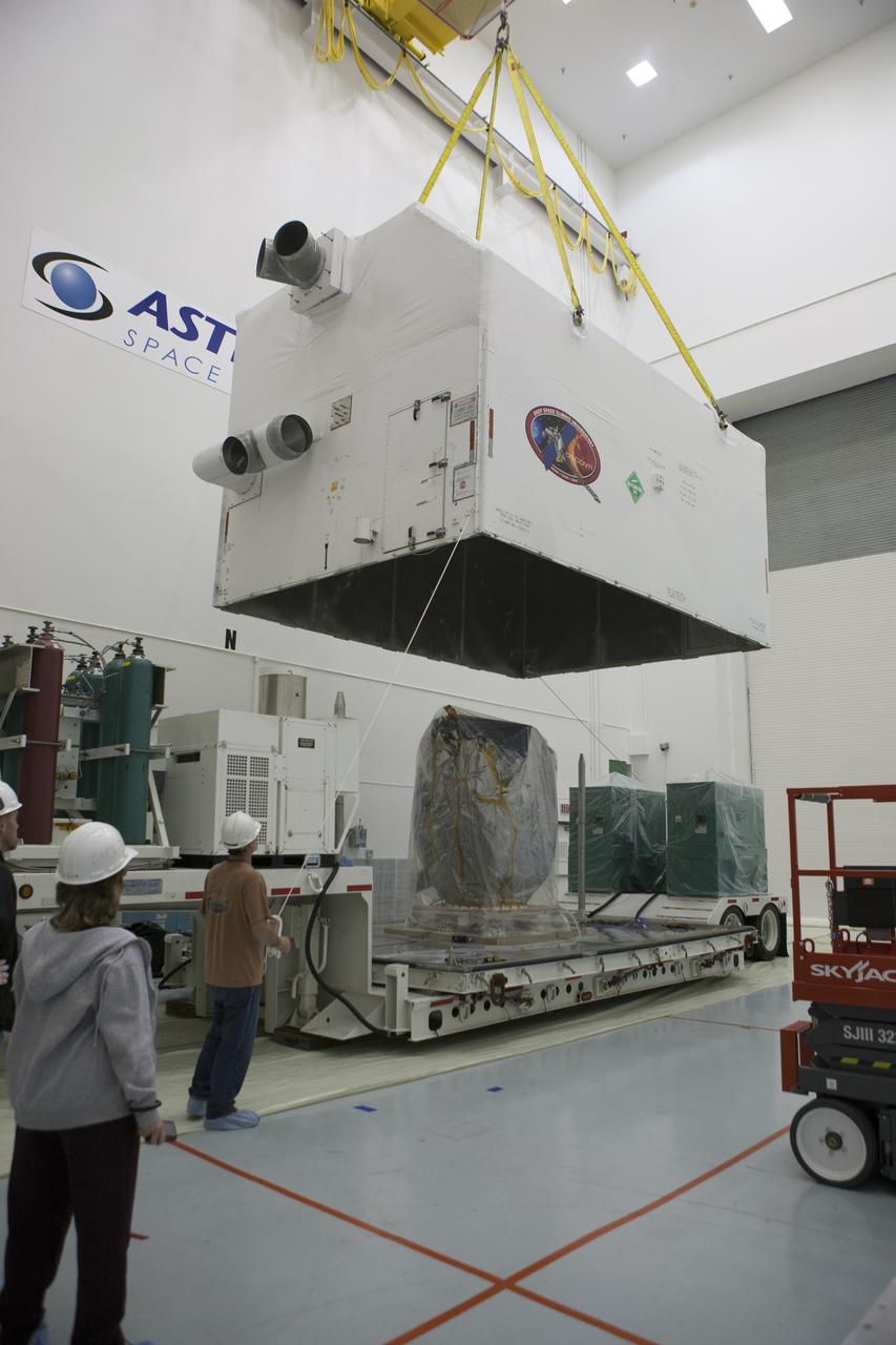 NOAA’s Deep Space Climate Observatory spacecraft, or DSCOVR, wrapped in plastic, comes into view as the protective shipping container is lifted from around the spacecraft at the Astrotech payload processing facility in Titusville, Florida, near Kennedy Space Center. DSCOVR is a partnership between NOAA, NASA and the U.S. Air Force. DSCOVR will maintain the nation's real-time solar wind monitoring capabilities which are critical to the accuracy and lead time of NOAA's space weather alerts and forecasts. Launch is currently scheduled for January 2015 aboard a SpaceX Falcon 9 v 1.1 launch vehicle from Cape Canaveral Air Force Station, Florida.