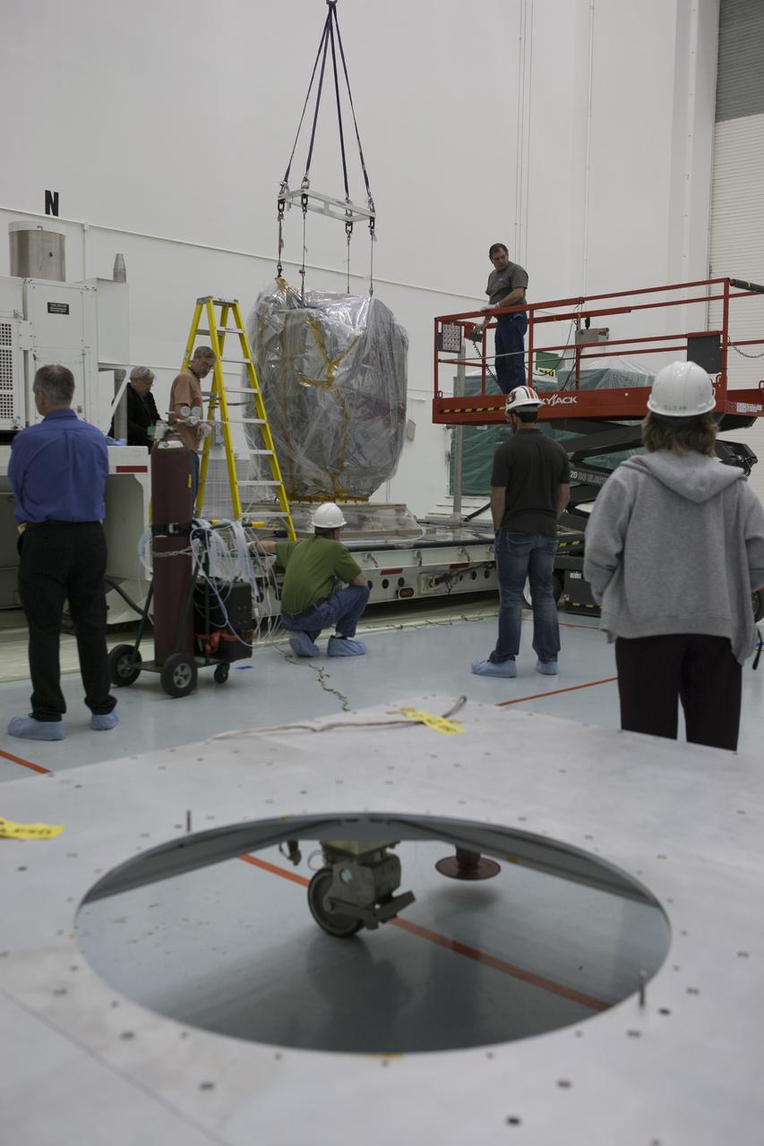 A lifting device is attached to NOAA’s Deep Space Climate Observatory spacecraft, or DSCOVR, wrapped in plastic, to remove it from its transportation pallet at the Astrotech payload processing facility in Titusville, Florida, near Kennedy Space Center. DSCOVR is a partnership between NOAA, NASA and the U.S. Air Force. DSCOVR will maintain the nation's real-time solar wind monitoring capabilities which are critical to the accuracy and lead time of NOAA's space weather alerts and forecasts. Launch is currently scheduled for January 2015 aboard a SpaceX Falcon 9 v 1.1 launch vehicle from Cape Canaveral Air Force Station, Florida.