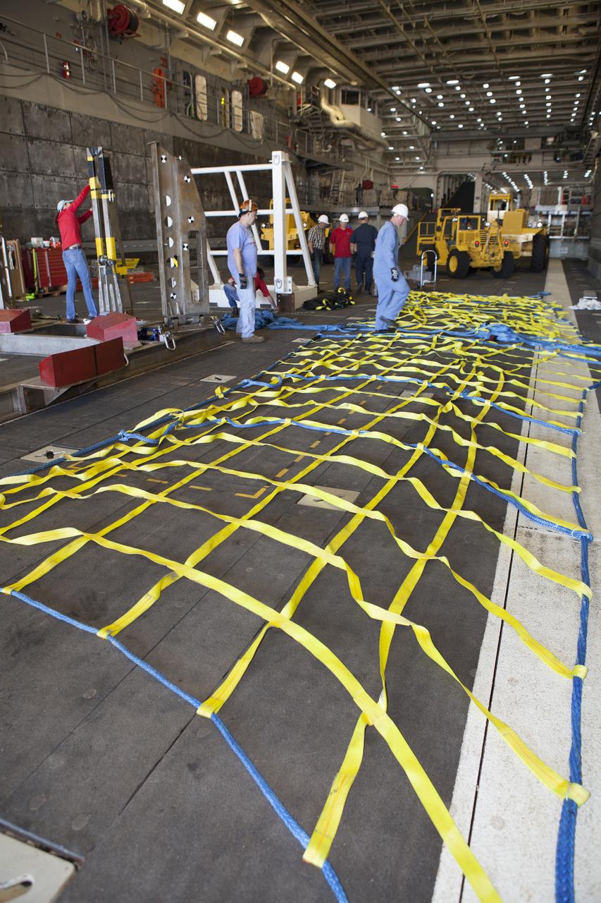 Ground support equipment is being secured in the well deck of the USS Anchorage at Naval Base San Diego in California. The equipment will be used during recovery of the Orion crew module after its first flight test. Before launch of Orion on a Delta IV Heavy rocket from Cape Canaveral Air Force Station in Florida, NASA, Lockheed Martin and U.S. Navy personnel will head out to sea in the USS Anchorage and the USNS Salvor, a salvage ship, and wait for splashdown of the Orion crew module in the Pacific Ocean. The Ground Systems Development and Operations Program will lead the recovery efforts. Orion is the exploration spacecraft designed to carry astronauts to destinations not yet explored by humans, including an asteroid and Mars. It will have emergency abort capability, sustain the crew during space travel and provide safe re-entry from deep space return velocities. The first unpiloted flight test of Orion is scheduled to launch in December atop a United Launch Alliance Delta IV Heavy rocket and in 2018 on NASA’s Space Launch System rocket. 