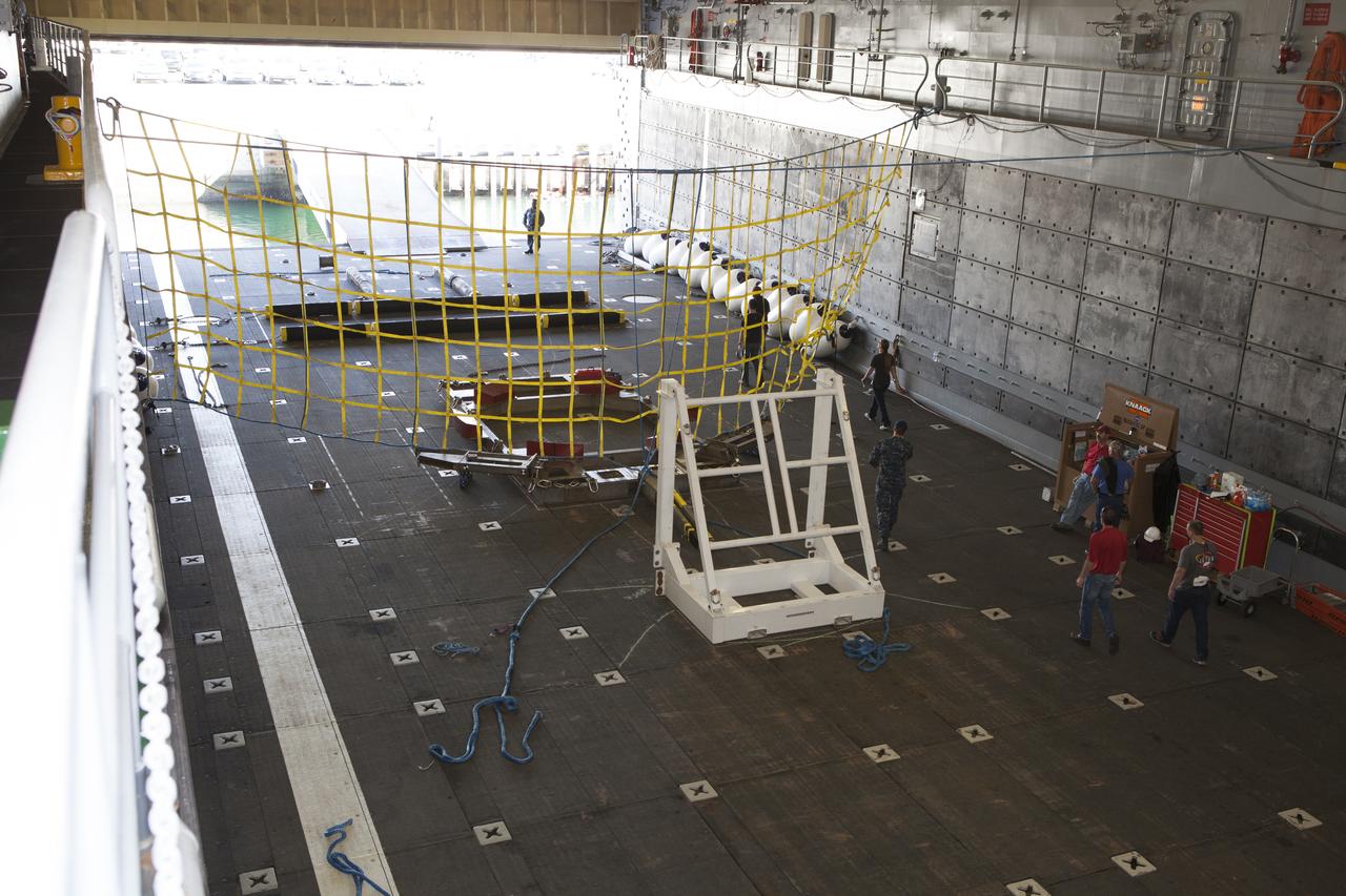 The Orion handling fixture and other ground support equipment is secured in the well deck of the USS Anchorage at Naval Base San Diego in California. The equipment will be used during recovery of the Orion crew module after its first flight test. Before launch of Orion on a Delta IV Heavy rocket from Cape Canaveral Air Force Station in Florida, NASA, Lockheed Martin and U.S. Navy personnel will head out to sea in the USS Anchorage and the USNS Salvor, a salvage ship, and wait for splashdown of the Orion crew module in the Pacific Ocean. The Ground Systems Development and Operations Program will lead the recovery efforts. Orion is the exploration spacecraft designed to carry astronauts to destinations not yet explored by humans, including an asteroid and Mars. It will have emergency abort capability, sustain the crew during space travel and provide safe re-entry from deep space return velocities. The first unpiloted flight test of Orion is scheduled to launch in December atop a United Launch Alliance Delta IV Heavy rocket and in 2018 on NASA’s Space Launch System rocket. 