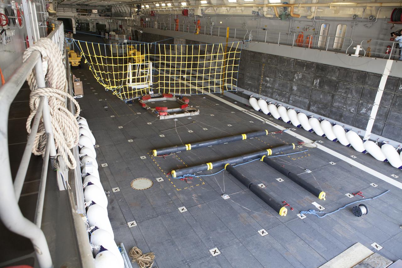 The Orion handling fixture, special bumpers and other ground support equipment are secured in the well deck of the USS Anchorage at Naval Base San Diego in California. The equipment will be used during recovery of the Orion crew module after its first flight test. Before launch of Orion on a Delta IV Heavy rocket from Cape Canaveral Air Force Station in Florida, NASA, Lockheed Martin and U.S. Navy personnel will head out to sea in the USS Anchorage and the USNS Salvor, a salvage ship, and wait for splashdown of the Orion crew module in the Pacific Ocean. The Ground Systems Development and Operations Program will lead the recovery efforts. Orion is the exploration spacecraft designed to carry astronauts to destinations not yet explored by humans, including an asteroid and Mars. It will have emergency abort capability, sustain the crew during space travel and provide safe re-entry from deep space return velocities. The first unpiloted flight test of Orion is scheduled to launch in December atop a United Launch Alliance Delta IV Heavy rocket and in 2018 on NASA’s Space Launch System rocket. 