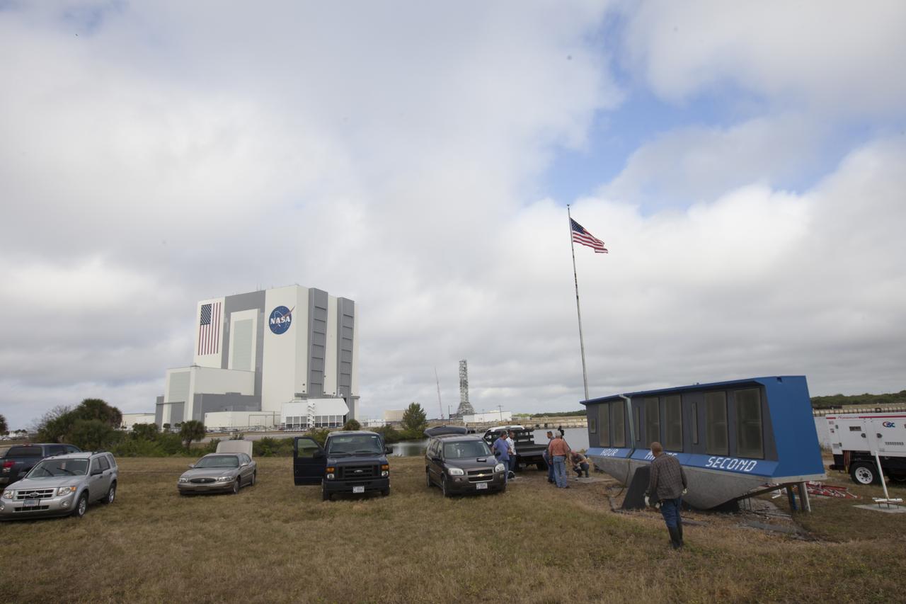 At NASA's Kennedy Space Center in Florida, the historic countdown clock at the spaceport's Press Site is disassembled for removal. Kennedy has requested to acquire the countdown clock from the agency’s Artifact Working Group at NASA Headquarters for likely display at the Kennedy Space Center Visitor Complex. A new modern multimedia display soon will be installed, similar to the screens seen at sporting venues, is in the works. The new screen will be nearly 26 feet wide by 7 feet high. The old timepiece was designed by Kennedy engineers and built by Kennedy technicians in 1969. Not including the triangular concrete and aluminum base, the famous landmark is nearly six feet high, 26 feet wide and 3 feet deep. The new display will be similar in size, with the screen being nearly 26 feet wide by seven feet high.