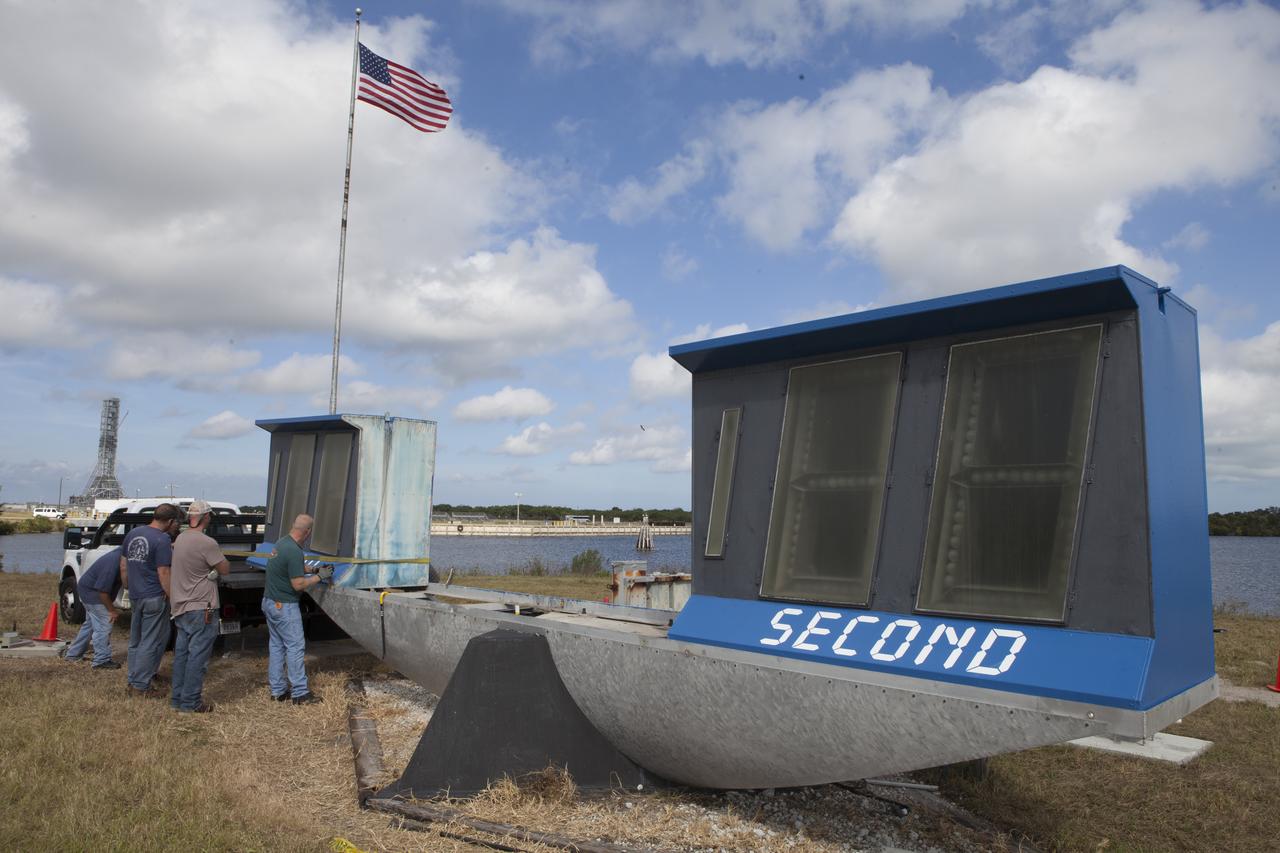 At NASA's Kennedy Space Center in Florida, the historic countdown clock at the spaceport's Press Site is disassembled for removal. Kennedy has requested to acquire the countdown clock from the agency’s Artifact Working Group at NASA Headquarters for likely display at the Kennedy Space Center Visitor Complex. A new modern multimedia display soon will be installed, similar to the screens seen at sporting venues, is in the works. The new screen will be nearly 26 feet wide by 7 feet high. The old timepiece was designed by Kennedy engineers and built by Kennedy technicians in 1969. Not including the triangular concrete and aluminum base, the famous landmark is nearly six feet high, 26 feet wide and 3 feet deep. The new display will be similar in size, with the screen being nearly 26 feet wide by seven feet high. 
