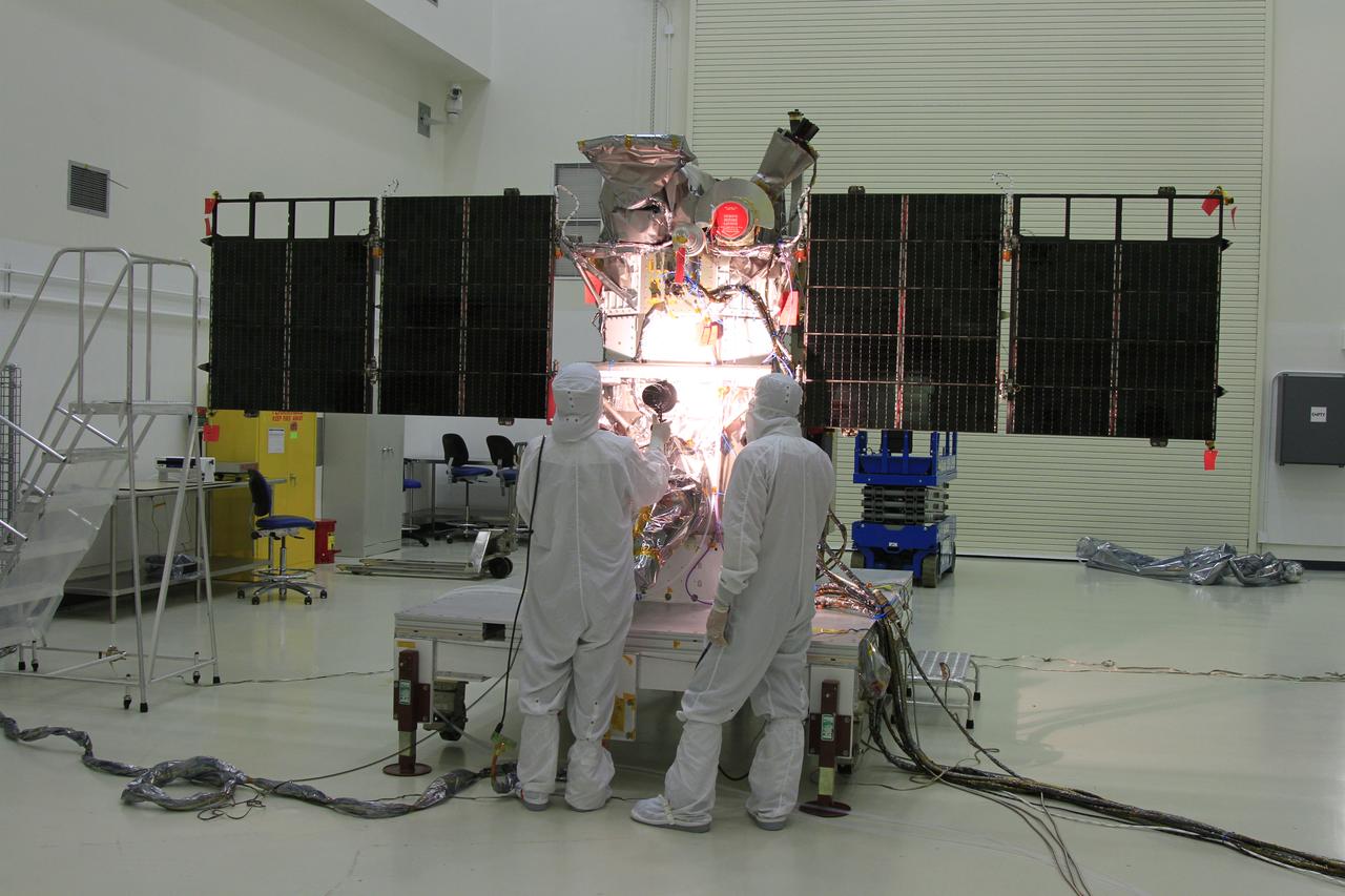 Workers conduct a light test on the solar arrays on NOAA’s Deep Space Climate Observatory spacecraft, or DSCOVR, in the Building 1 high bay at the Astrotech payload processing facility in Titusville, Florida, near Kennedy Space Center. DSCOVR is a partnership between NOAA, NASA and the U.S. Air Force. DSCOVR will maintain the nation's real-time solar wind monitoring capabilities which are critical to the accuracy and lead time of NOAA's space weather alerts and forecasts. Launch is targeted for early 2015 aboard a SpaceX Falcon 9 v 1.1 launch vehicle from Cape Canaveral Air Force Station, Florida. 