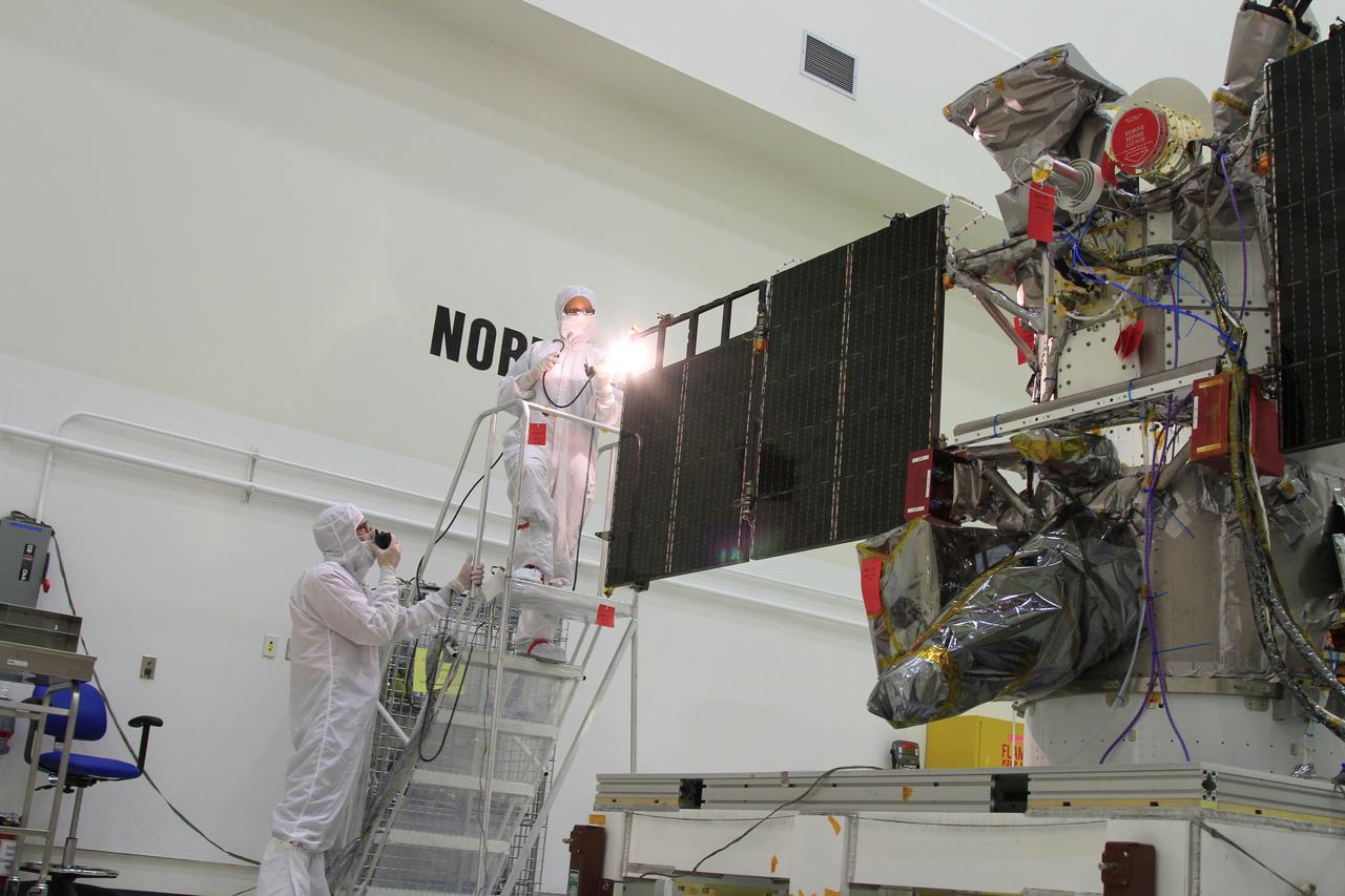 Workers conduct a light test on the solar arrays on NOAA’s Deep Space Climate Observatory spacecraft, or DSCOVR, in the Building 1 high bay at the Astrotech payload processing facility in Titusville, Florida, near Kennedy Space Center. DSCOVR is a partnership between NOAA, NASA and the U.S. Air Force. DSCOVR will maintain the nation's real-time solar wind monitoring capabilities which are critical to the accuracy and lead time of NOAA's space weather alerts and forecasts. Launch is targeted for early 2015 aboard a SpaceX Falcon 9 v 1.1 launch vehicle from Cape Canaveral Air Force Station, Florida.