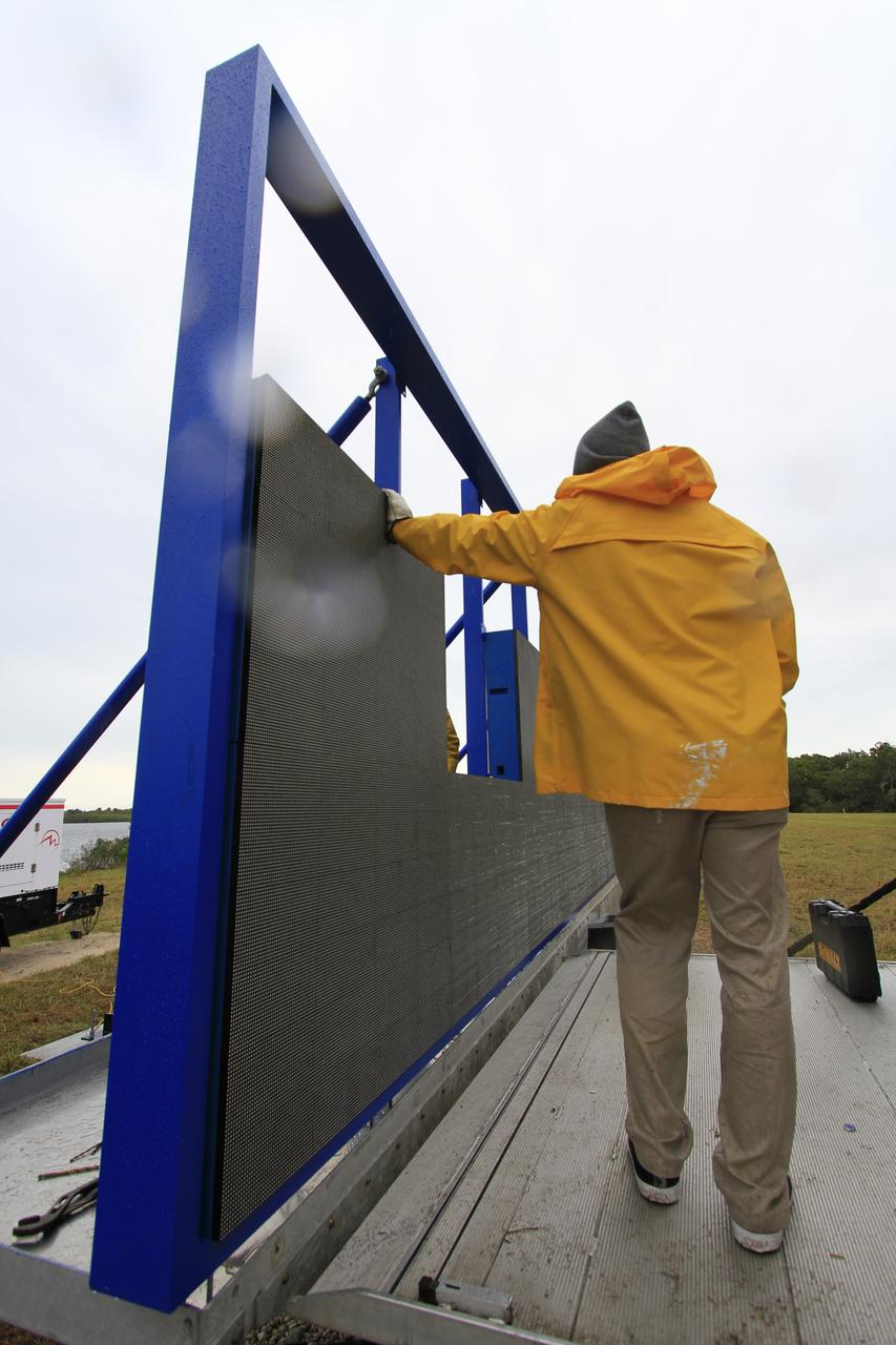 At NASA's Kennedy Space Center in Florida, work continues to install 24 light emitting diode LED panels in the new countdown clock at the spaceport's Press Site. The modern, multimedia display is similar to the screens seen at sporting venues. The new screen will be nearly 26 feet wide by 7 feet high, a foot taller than the original clock. The historic countdown clock was designed by Kennedy engineers and built by space center technicians before Apollo 12 in 1969. NASA has requested to acquire the countdown clock from the agency’s Artifact Working Group at the agency's Headquarters for likely display at the Kennedy Space Center Visitor Complex. 