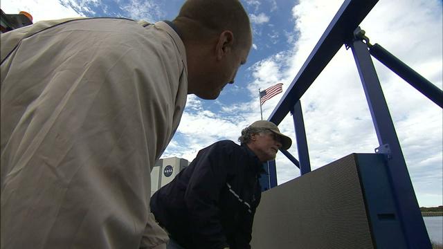 At NASA's Kennedy Space Center in Florida, work continues to install 24 light emitting diode LED panels in the new countdown clock at the spaceport's Press Site. The modern, multimedia display is similar to the screens seen at sporting venues. The new screen will be nearly 26 feet wide by 7 feet high, a foot taller than the original clock. The historic countdown clock was designed by Kennedy engineers and built by space center technicians before Apollo 12 in 1969. NASA has requested to acquire the countdown clock from the agency’s Artifact Working Group at the agency's Headquarters for display at the Kennedy Space Center Visitor Complex.