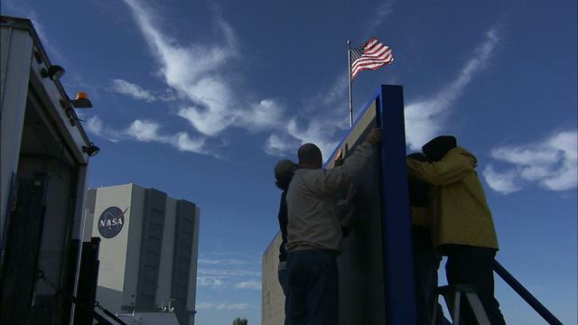 At NASA's Kennedy Space Center in Florida, work continues to install 24 light emitting diode LED panels in the new countdown clock at the spaceport's Press Site. The modern, multimedia display is similar to the screens seen at sporting venues. The new screen will be nearly 26 feet wide by 7 feet high, a foot taller than the original clock. The historic countdown clock was designed by Kennedy engineers and built by space center technicians before Apollo 12 in 1969. NASA has requested to acquire the countdown clock from the agency’s Artifact Working Group at the agency's Headquarters for display at the Kennedy Space Center Visitor Complex.