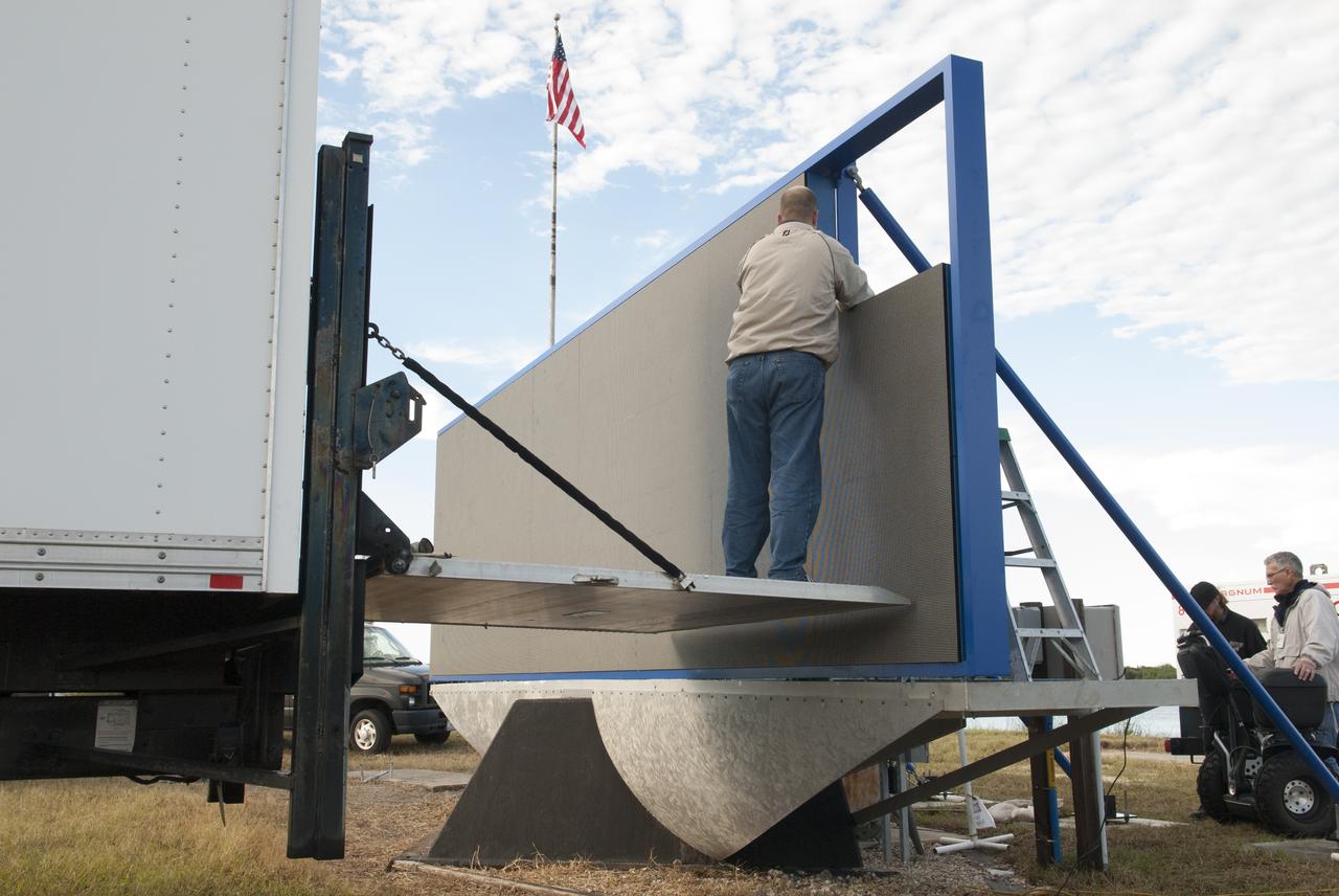 At NASA's Kennedy Space Center in Florida, work continues to install 24 light emitting diode LED panels in the new countdown clock at the spaceport's Press Site. The modern, multimedia display is similar to the screens seen at sporting venues. The new screen will be nearly 26 feet wide by 7 feet high, a foot taller than the original clock. The historic countdown clock was designed by Kennedy engineers and built by space center technicians before Apollo 12 in 1969. NASA has requested to acquire the countdown clock from the agency’s Artifact Working Group at the agency's Headquarters for display at the Kennedy Space Center Visitor Complex.