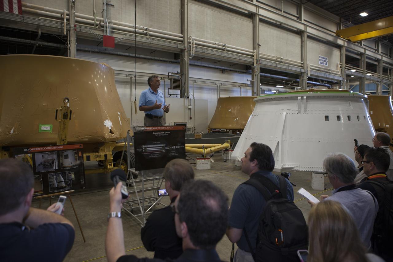 At NASA's Kennedy Space Center in Florida, members of the news media are briefed on the agency's Space Launch System SLS Program by Larry Clark, engineering manager for Alliant Techsystems Inc. ATK. The briefing took place in the spaceport's Booster Fabrication Facility BFF. During the Space Shuttle Program, the facility was used for processing forward segments and aft skirts for the solid rocket boosters. The BFF will serve a similar role for the SLS. Orion is the exploration spacecraft designed to carry astronauts to destinations not yet explored by humans, including an asteroid and Mars. It will have emergency abort capability, sustain the crew during space travel and provide safe re-entry from deep space return velocities. The first unpiloted flight test of Orion is scheduled to launch Dec. 4, 2014 atop a United Launch Alliance Delta IV Heavy rocket, and in 2018 on NASA’s Space Launch System rocket.