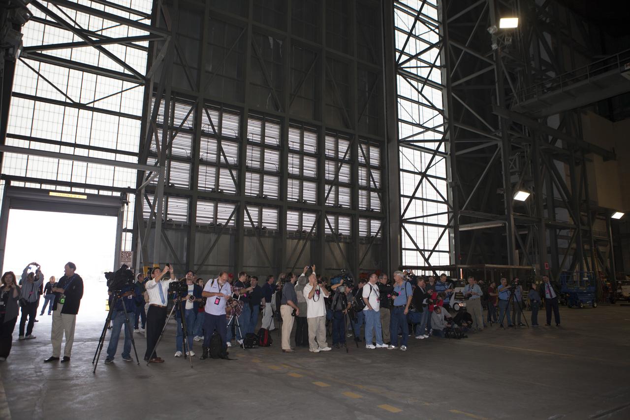 At NASA's Kennedy Space Center in Florida, members of the news media tour the spaceport's Vehicle Assembly Building VAB. Like the Apollo Saturn V and space shuttles of the past, the Space Launch System rocket will be stacked and checked out in the VAB prion to being rolled to the launch pad. Orion is the exploration spacecraft designed to carry astronauts to destinations not yet explored by humans, including an asteroid and Mars. It will have emergency abort capability, sustain the crew during space travel and provide safe re-entry from deep space return velocities. The first unpiloted flight test of Orion is scheduled to launch Dec. 4, 2014 atop a United Launch Alliance Delta IV Heavy rocket, and in 2018 on NASA’s Space Launch System rocket.