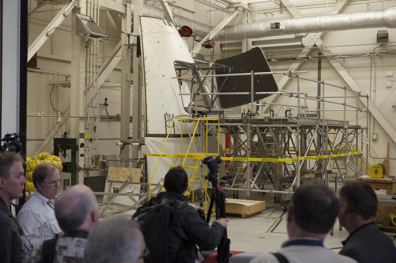 At NASA's Kennedy Space Center in Florida, members of the news media tour the spaceport's Vehicle Assembly Building. They were shown an ogive panel which, together with others, cover the Orion spacecraft during launch. Orion is the exploration spacecraft designed to carry astronauts to destinations not yet explored by humans, including an asteroid and Mars. It will have emergency abort capability, sustain the crew during space travel and provide safe re-entry from deep space return velocities. The first unpiloted flight test of Orion is scheduled to launch Dec. 4, 2014 atop a United Launch Alliance Delta IV Heavy rocket, and in 2018 on NASA’s Space Launch System rocket.