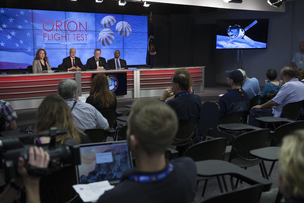 In the Kennedy Space Center’s Press Site auditorium, news media members listen as agency and industry leaders the status of preparations for launch of the Orion spacecraft atop a Delta IV Heavy rocket. From left are: Brandi Dean of NASA Public Affairs, Mark Geyer, Orion program manager, Mike Hawes, Lockheed Martin Orion Program manager, and Ron Fortson, United Launch Alliance director of mission management. Orion is the exploration spacecraft designed to carry astronauts to destinations not yet explored by humans, including an asteroid and Mars. It will have emergency abort capability, sustain the crew during space travel and provide safe re-entry from deep space return velocities. The first unpiloted flight test of Orion is scheduled to launch Dec. 4, 2014 atop a United Launch Alliance Delta IV Heavy rocket, and in 2018 on NASA’s Space Launch System rocket.