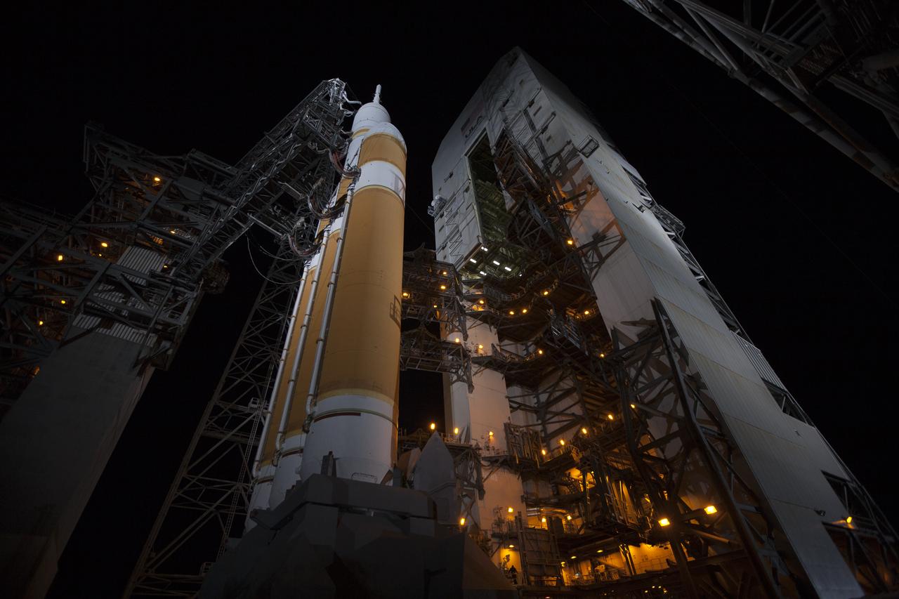 The launch gantry is rolled back to reveal NASA's Orion spacecraft mounted atop a United Launch Alliance Delta IV Heavy rocket at Cape Canaveral Air Force Station's Space Launch Complex 37. Orion is NASA’s new spacecraft built to carry humans, designed to allow us to journey to destinations never before visited by humans, including an asteroid and Mars.