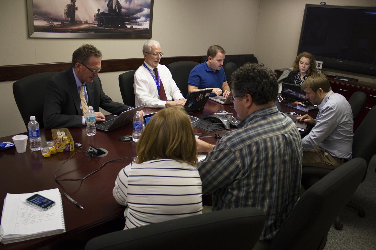 NASA managers participate in a live online Ask Me Anything, or AMA, session for reddit.com followers during Orion preflight activities at NASA Kennedy Space Center's News Center in Florida. From left, are Mike Bolger, Ground Systems Development and Operations program manager; and Mark Geyer, Orion program manager. Across from them, in the plaid shirt is Todd May, Space Launch System program manager. Discussion topics include Mars and technology. 