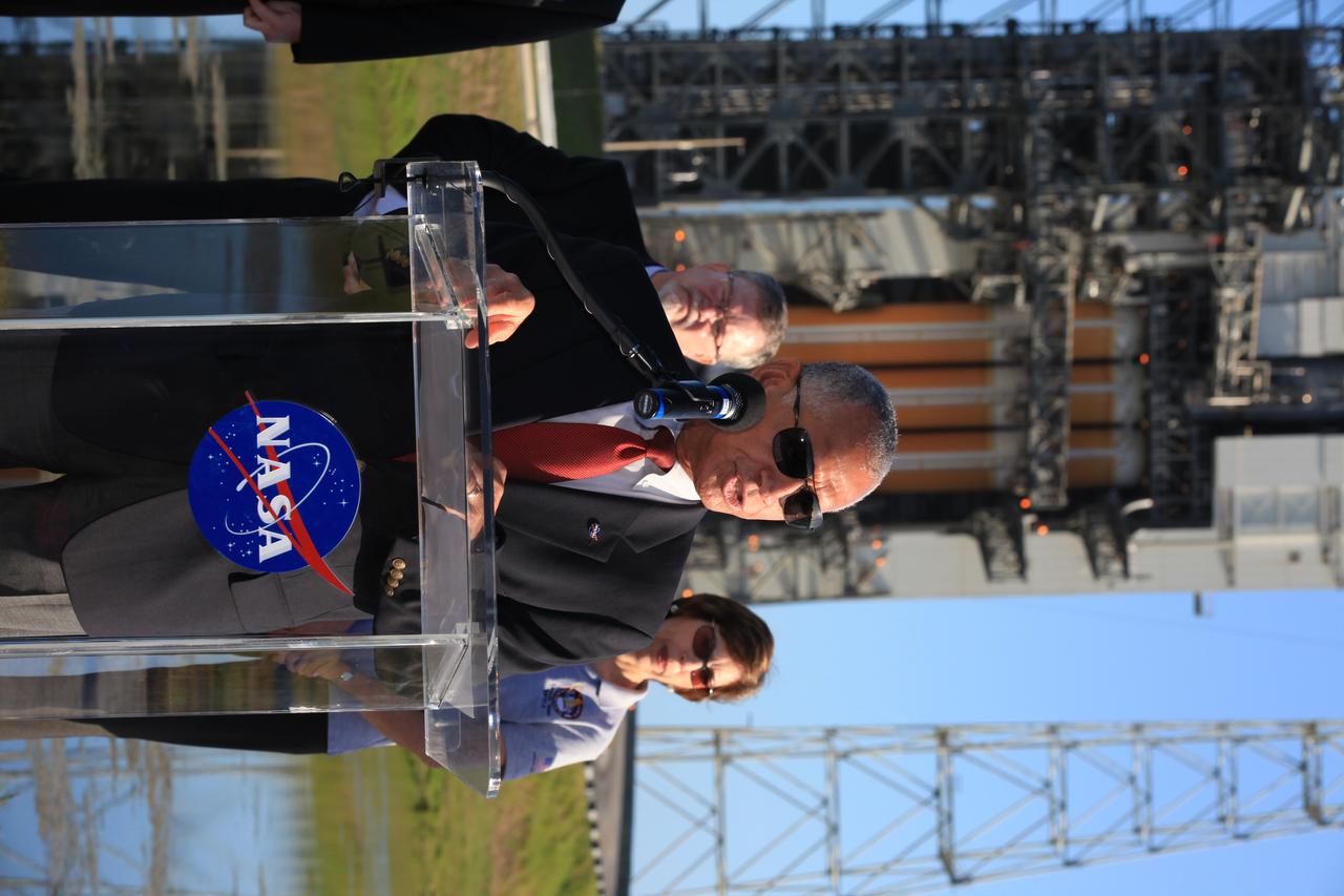 At Cape Canaveral Air Force Station's Launch Complex 37, NASA Administrator Charlie Bolden speaks to members of the news media as the Orion spacecraft and its United Launch Alliance Delta IV Heavy rocket were being prepared for launch. Behind Bolden, from the left, are Lockheed Martin Orion Program Manager Mike Hawes and Johnson Space Center Director Ellen Ochoa.