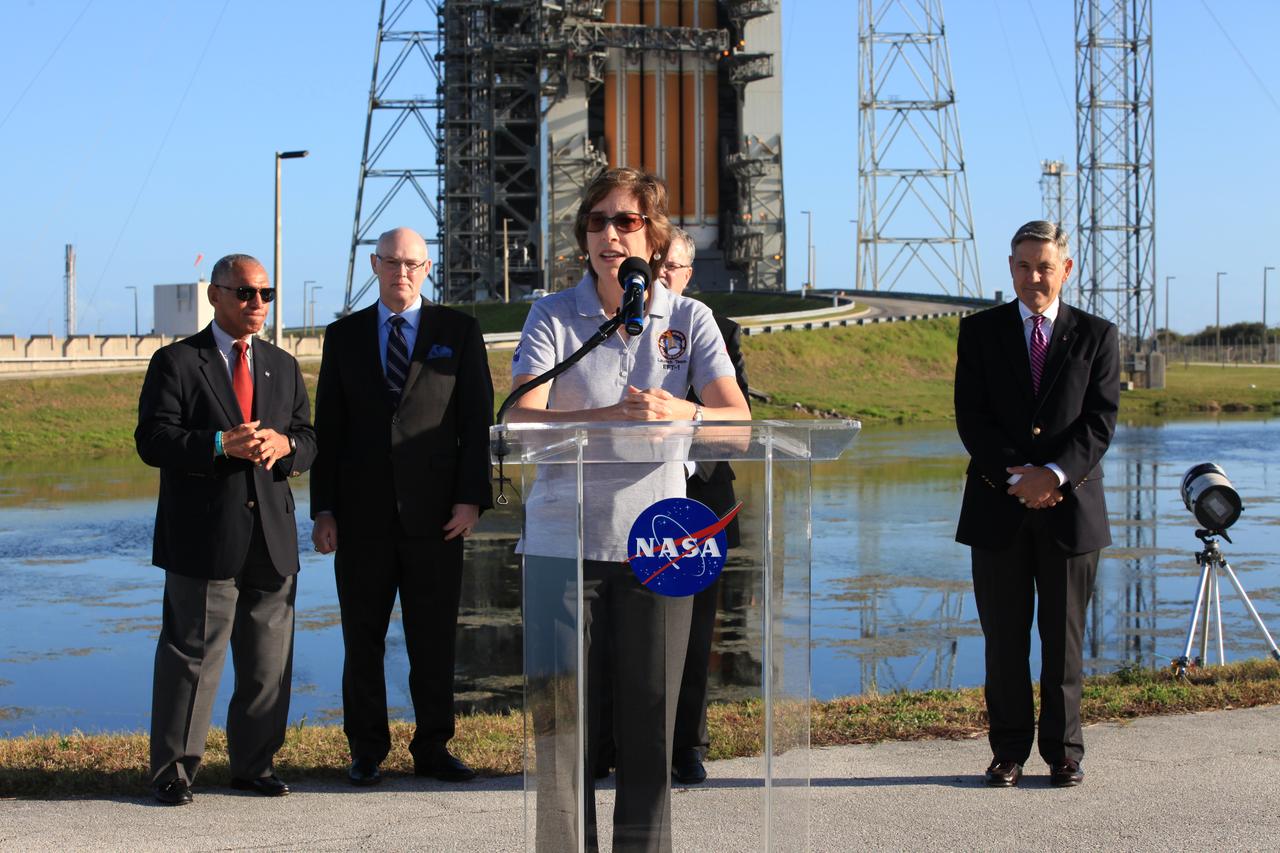 At Cape Canaveral Air Force Station's Launch Complex 37, Johnson Space Center Director Ellen Ochoa speaks to members of the news media as the Orion spacecraft and its United Launch Alliance Delta IV Heavy rocket were being prepared for launch. Behind Ochoa, from the left, are NASA Administrator Charlie Bolden, United Launch Alliance CEO Tory Bruno, Lockheed Martin Orion Program Manager Mike Hawes and Kennedy Space Center Director Bob Cabana.