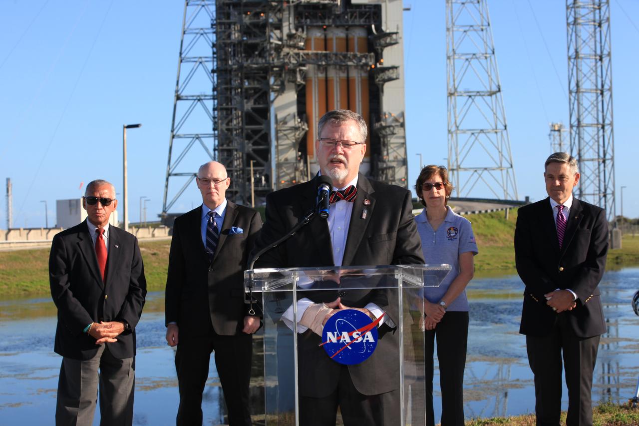 At Cape Canaveral Air Force Station's Launch Complex 37, Lockheed Martin Orion Program manager Mike Hawes speaks to members of the news media as the Orion spacecraft and its United Launch Alliance Delta IV Heavy rocket were being prepared for launch. Behind Hawes, from the left, are NASA Administrator Charlie Bolden, United Launch Alliance CEO Tory Bruno, Johnson Space Center Director Ellen Ochoa and Kennedy Space Center Director Bob Cabana.