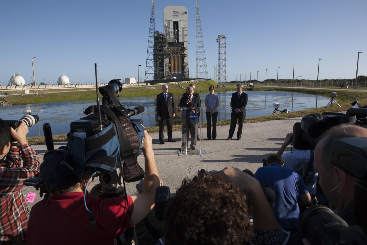 At Cape Canaveral Air Force Station's Launch Complex 37, NASA Administrator Charlie Bolden speaks to members of the news media as the Orion spacecraft and its United Launch Alliance Delta IV Heavy rocket are being prepared for launch. Behind Bolden, from the left, are United Launch Alliance CEO Tory Bruno, Lockheed Martin Orion Program Manager Mike Hawes partially hidden behind Bolden, Johnson Space Center Director Ellen Ochoa and Kennedy Space Center Director Bob Cabana.