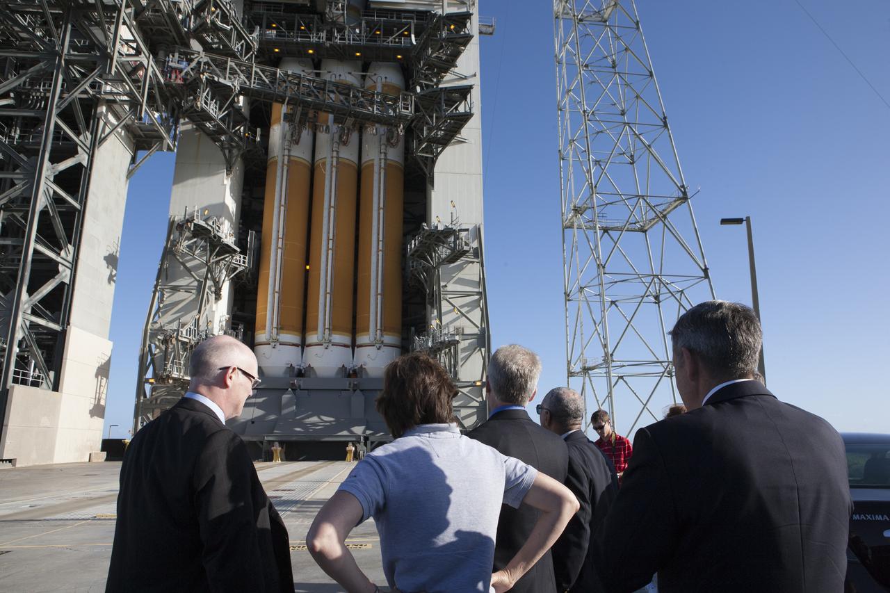 At Cape Canaveral Air Force Station's Launch Complex 37, United Launch Alliance CEO Tory Bruno, Johnson Space Center Director Ellen Ochoa and Kennedy Space Center Director Bob Cabana, foreground with backs to the camera, get a close-up view of the United Launch Alliance Delta IV Heavy rocket being prepared to launch NASA's Orion spacecraft on its first flight test.