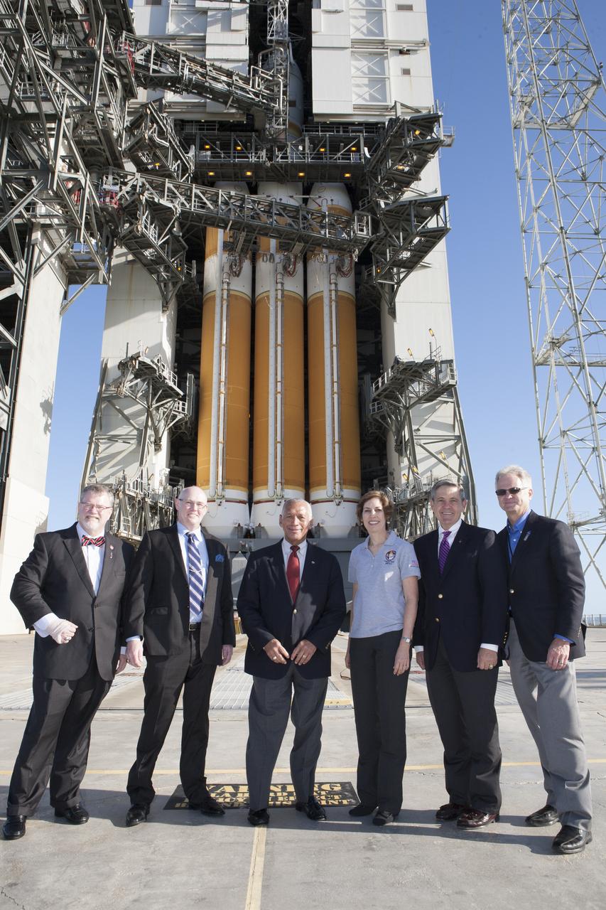 At Cape Canaveral Air Force Station's Launch Complex 37, NASA and industry leaders pose in front of the United Launch Alliance Delta IV heavy rocket poised to launch the Orion spacecraft on its first flight test.