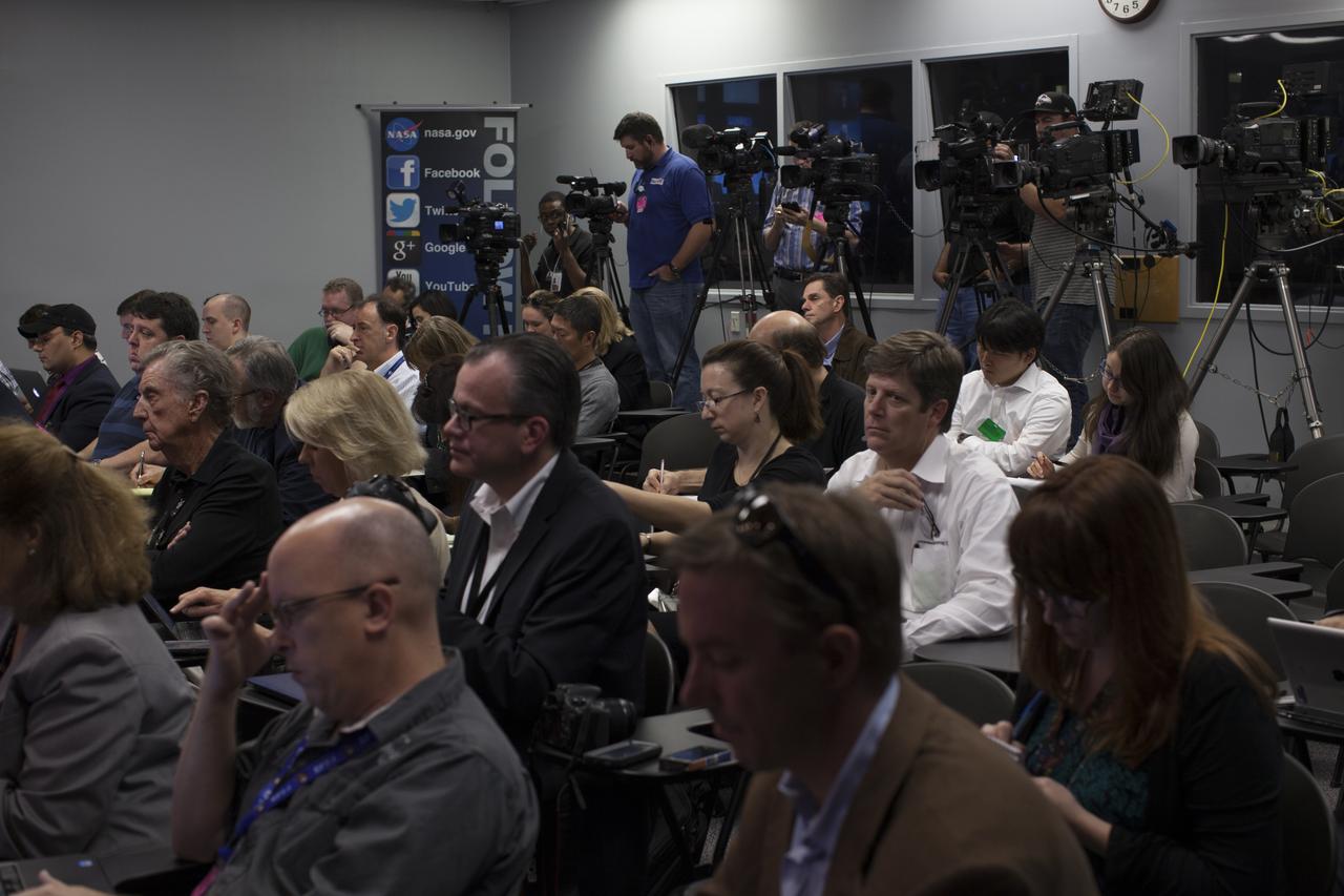 In the Kennedy Space Center’s Press Site auditorium, members of the news media listen as agency and industry leaders updated progress as the Orion spacecraft and its Delta IV Heavy rocket were being prepared for launch.