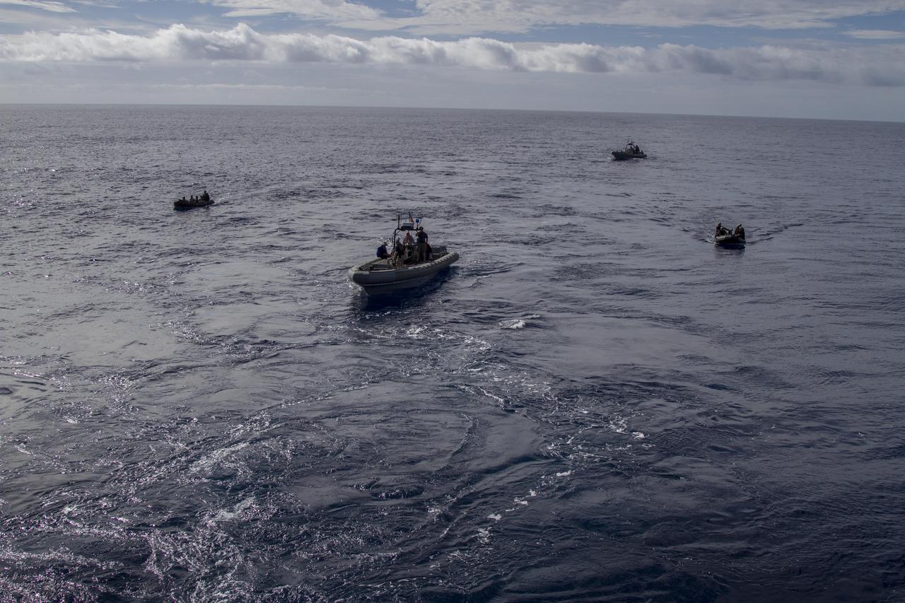 On the third day of preparations for recovery of Orion, U.S. Navy divers in two rigid hull inflatable boats and two Zodiac boats practice recovery procedures nearby the USS Anchorage in the Pacific Ocean about 600 miles off the coast of Baja, California. NASA, Lockheed Martin and U.S. Navy personnel are preparing for recovery of the Orion crew module, forward bay cover and parachutes after its return from space and splashdown in the Pacific Ocean. The Ground Systems Development and Operations Program is leading the recovery efforts. 